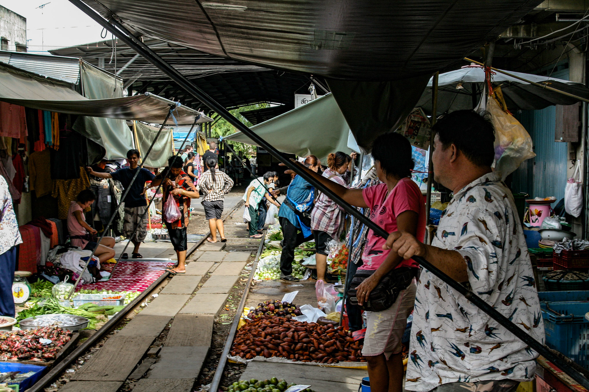 The tracks, which run right through the middle of the market are shielded in shade by large awnings suspended overhead. 