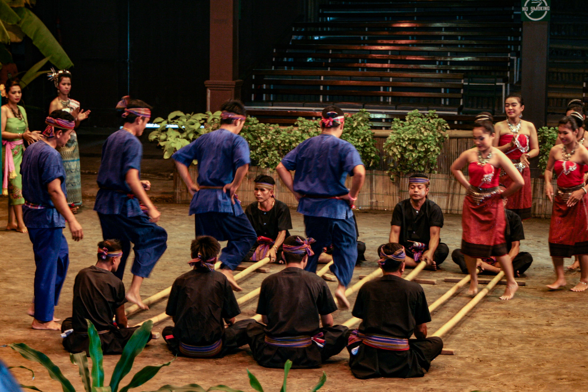Thai men and women perform the energetic Bamboo Dance of northeastern Thailand at the Rose Garden