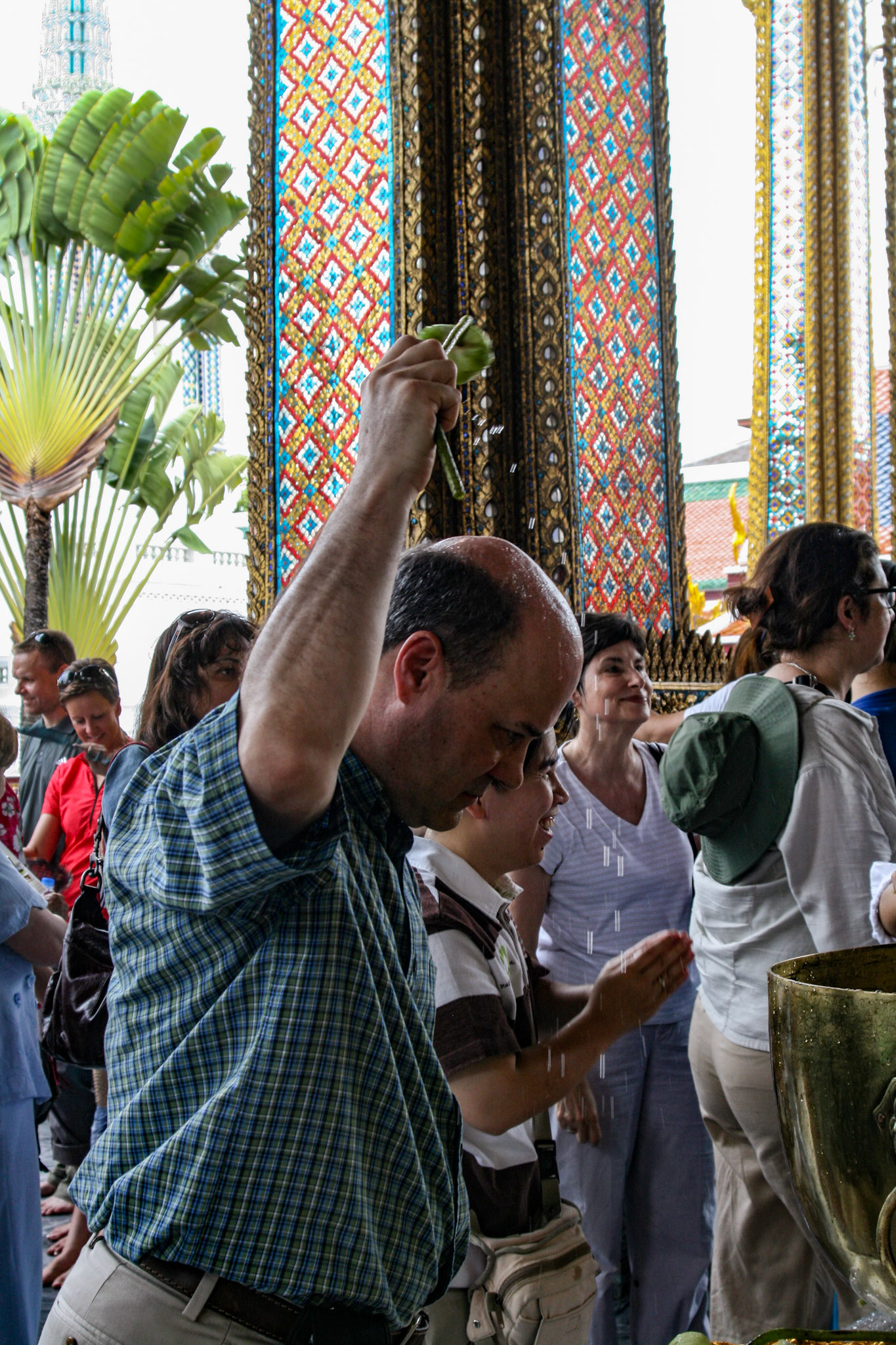 Michael Griffin seeks the benefits of the sacred waters in Bangkok at Wat Phra Kaew.