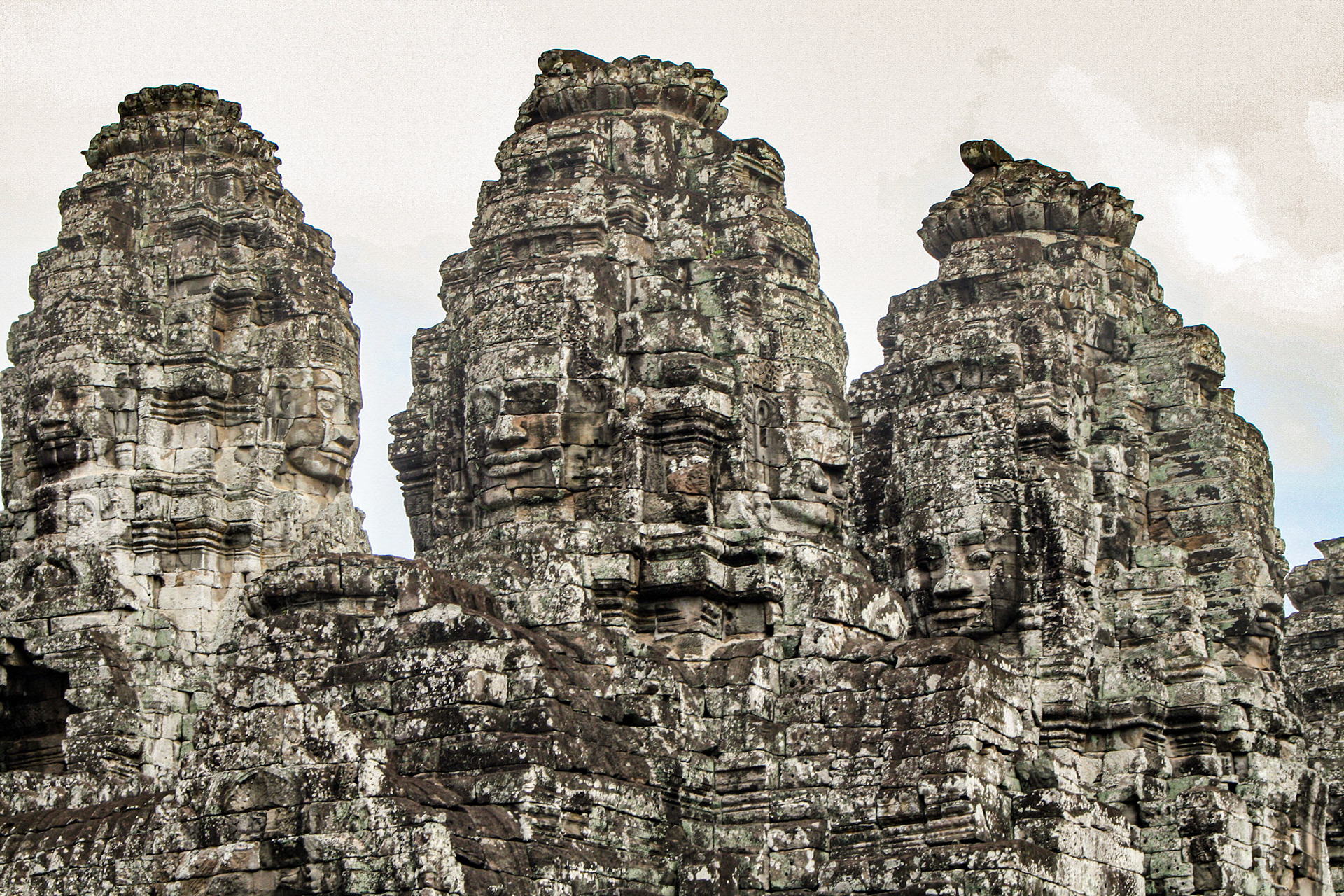 The Bayon's most distinctive feature is the multitude of serene and smiling stone faces on the many towers which jut out from the upper terrace and cluster around its central peak. 