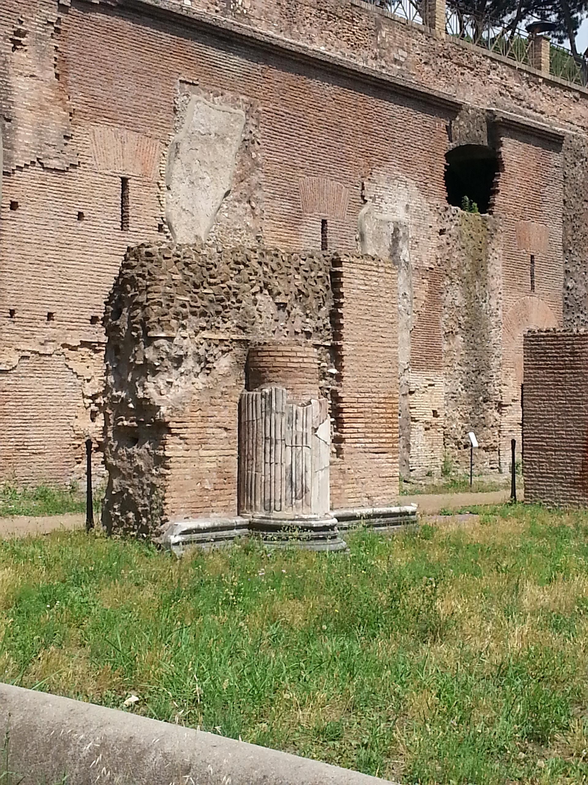 The Palatine Stadium was the third part of Domitian's palace on the Palatine Hill in Rome. It was the last to be built, after the Domus Flavia and the Domus Augustana, respectively the public and private parts of the complex. The stadium was a circus -shaped building, with a very elongated rectangle with a curved shorter side (the southern one) of about 160 x 48 meters. It occupies the entire eastern side of the Domus Augustana, for a total of about 88 meters. The perimeter was decorated by a two-story portico, composed on the lower level by brick pillars covered with marble (only the bases remain) and on the upper level by marble columns, as can be seen in part in the reconstruction of the northern corner. 