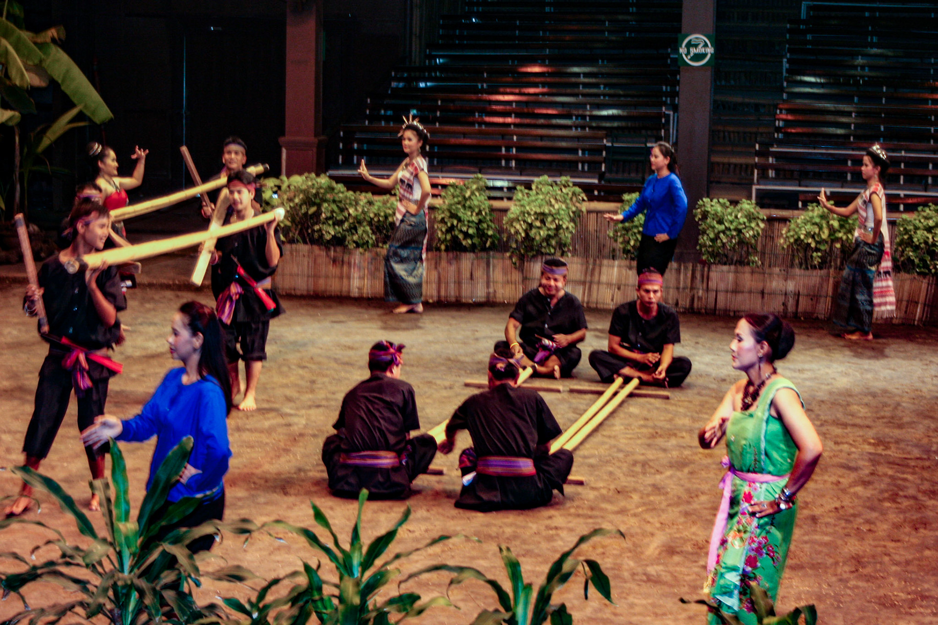 Thai men and women perform the energetic Bamboo Dance of northeastern Thailand at the Rose Garden