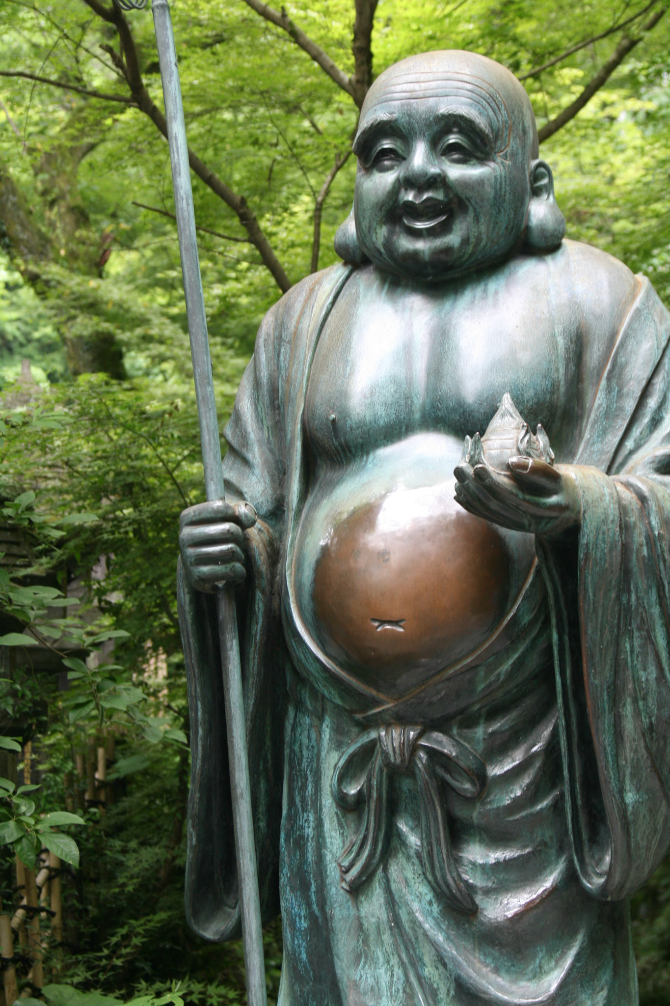 Happy Buddha with a belly shiny from visitors' hands rubbing it, Fukuoka, Japan