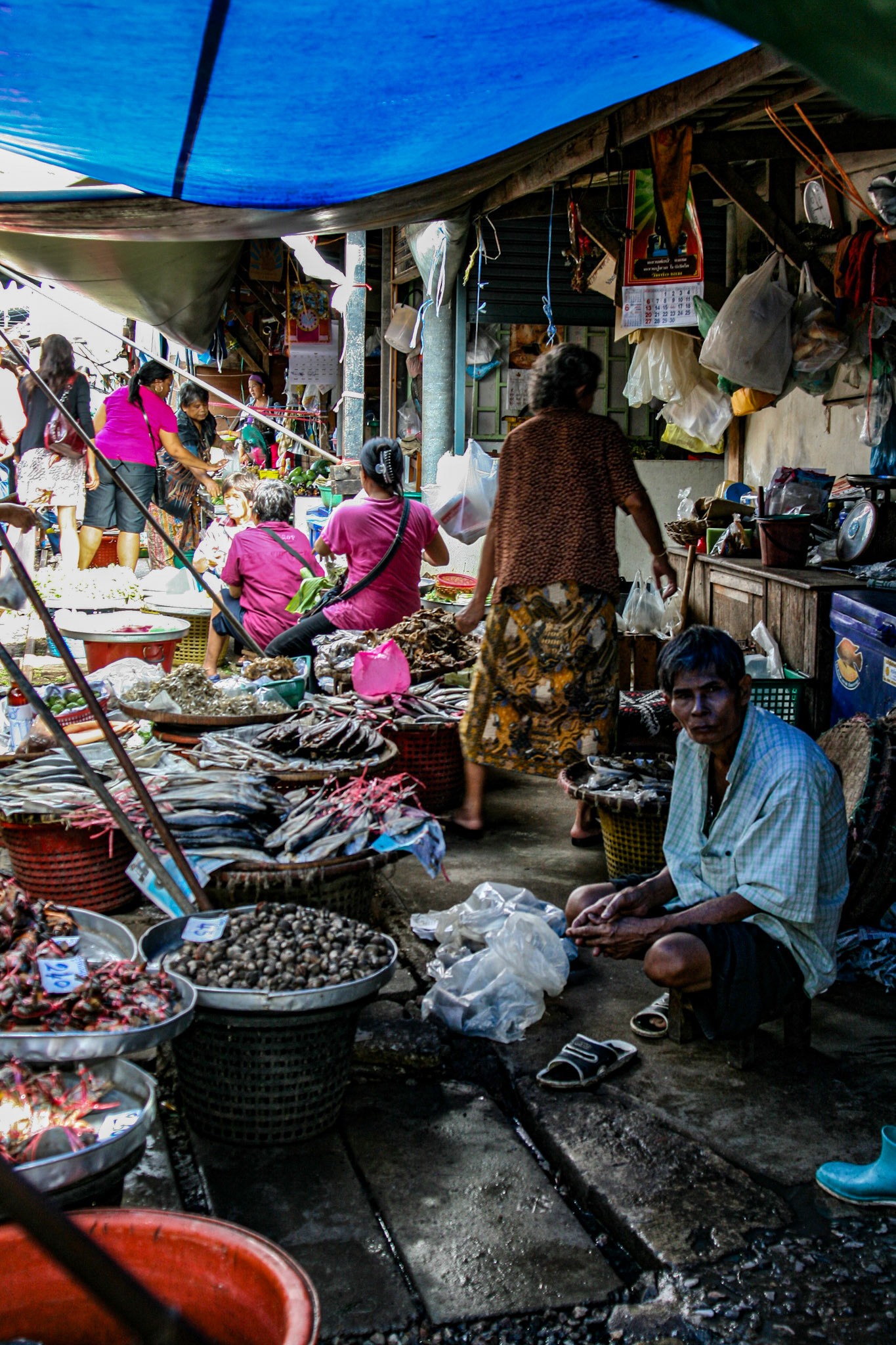 Shoppers make their way through and around the various vendors picking up whatever is needed for the day. 