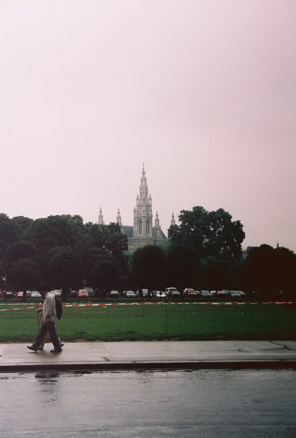 Vienna City Hall behind the green trees. View from the Heldenplatz square. The City Hall was built in 1872-1883 in the Neo-Gothic style. 
