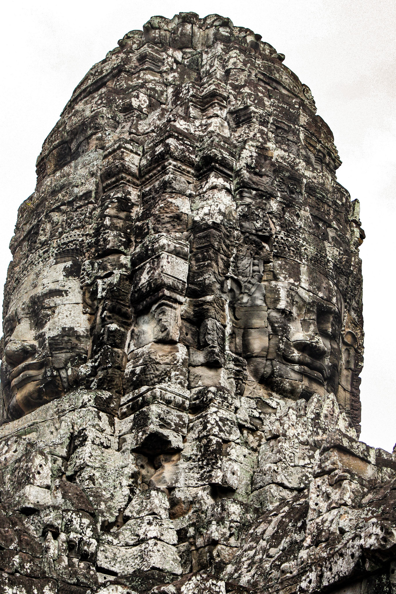 The Bayon's most distinctive feature is the multitude of serene and smiling stone faces on the many towers which jut out from the upper terrace and cluster around its central peak. 