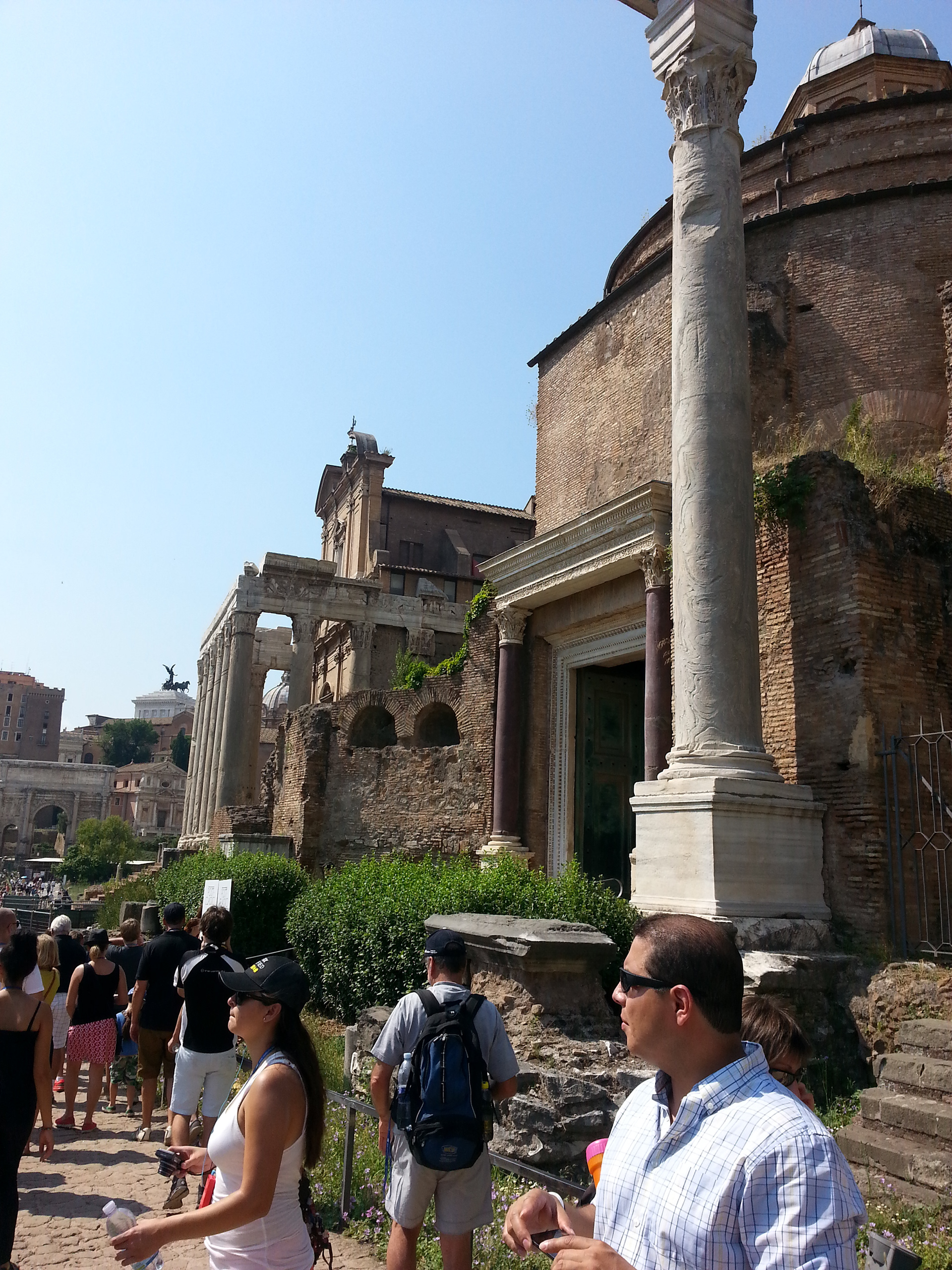 Set between two porphyry columns that support a reused marble architrave are the original bronze doors of the Temple of Divine Romulus, deified by his father Maxentius in AD 309, when the boy is presumed to have died. They open into a rotunda fifty Roman feet in diameter covered by a cupola, which now is accessible from the rear through the Basilica of Santi Cosma e Damiano. Early in the sixth century, the temple was converted into a vestibule for the church, which also occupied the southwest corner of the Temple of Peace, the first buildings in the forums to be Christianized. 