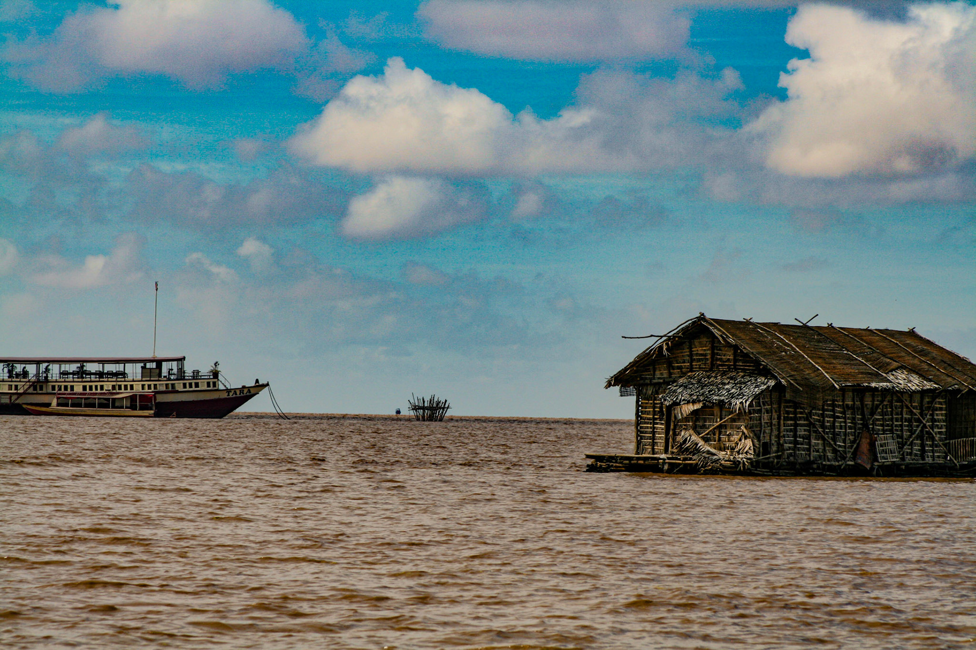 During the June-to-November monsoonal regime, the swollen Mekong reverses the southeastward flow of the Sab River, which increases Tonle Sap’s area from about 1,050 square miles (2,700 square km) to about 4,000 square miles (10,360 square km); its depth also increases from 3–10 feet (0.9–3 m) to 30–45 feet (9–14 m), permitting vessels with 9 feet (3 m) of draft to navigate it up through the various tributaries. 