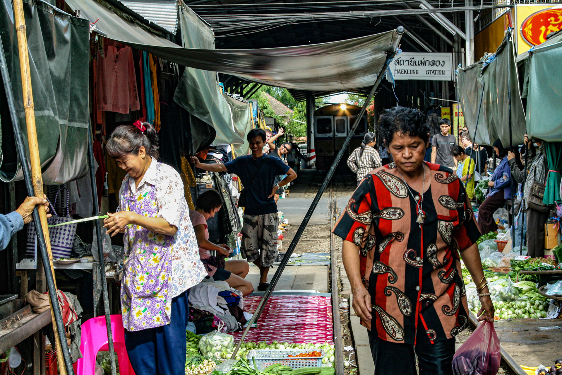 When a piercing siren sounds, in a flash the market transforms:  the shoppers disappear, and the vendors whip away their produce.