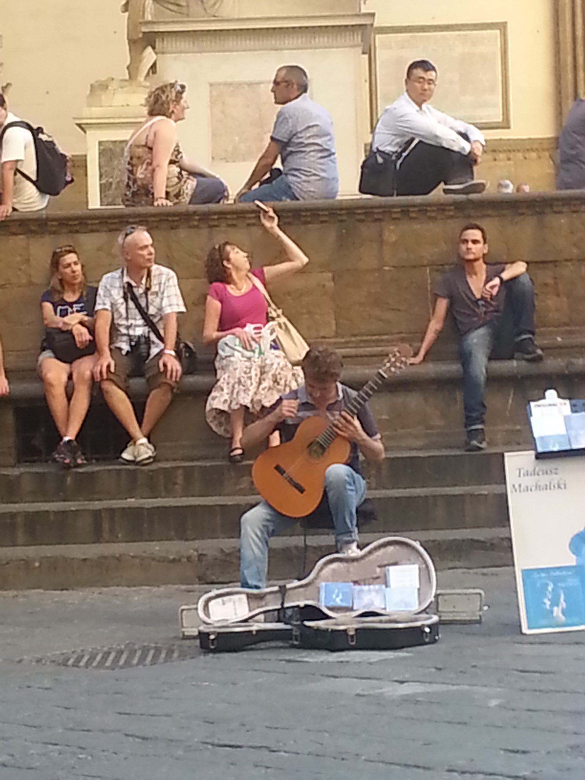 A musician serenades the crowd in the Piazza della Signoria (Signoria square), in front of the Palazzo Vecchio. 