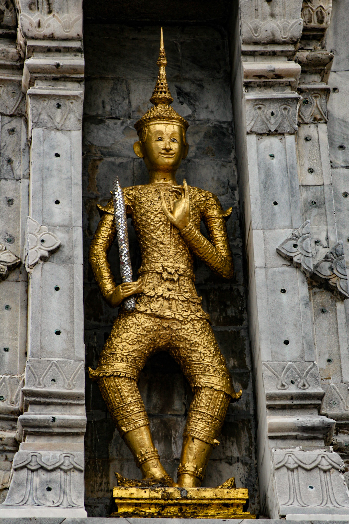 Khmer style statuary on four stupas in the Ordination Hall courtyard.