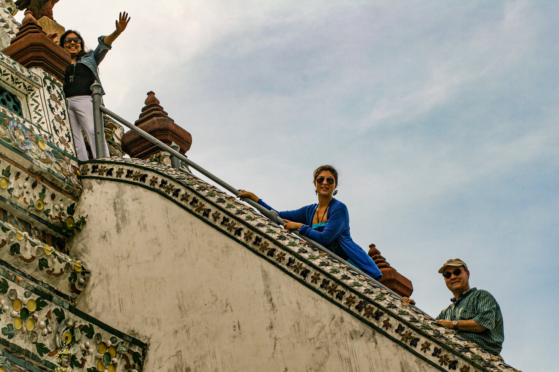 Shahira S. Fahmy waves as Ashley ? and Michael Griffin look on as they all ascend to the top of the shrine at Wat Arun, Temple of Dawn, Bangkok, Thailand.