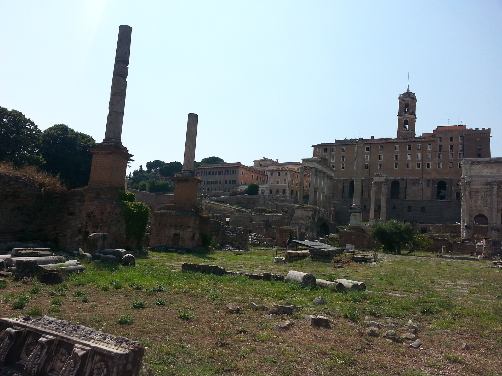 The Tabularium, behind the corner columns of the Temple of Vespasian and Titus and the Temple of Saturn. 
