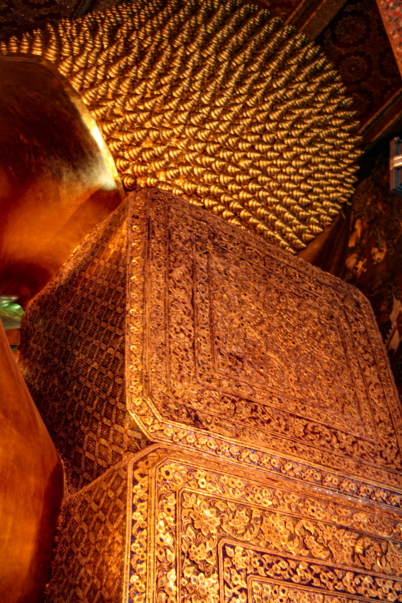 Head resting on two golden pillows detail.