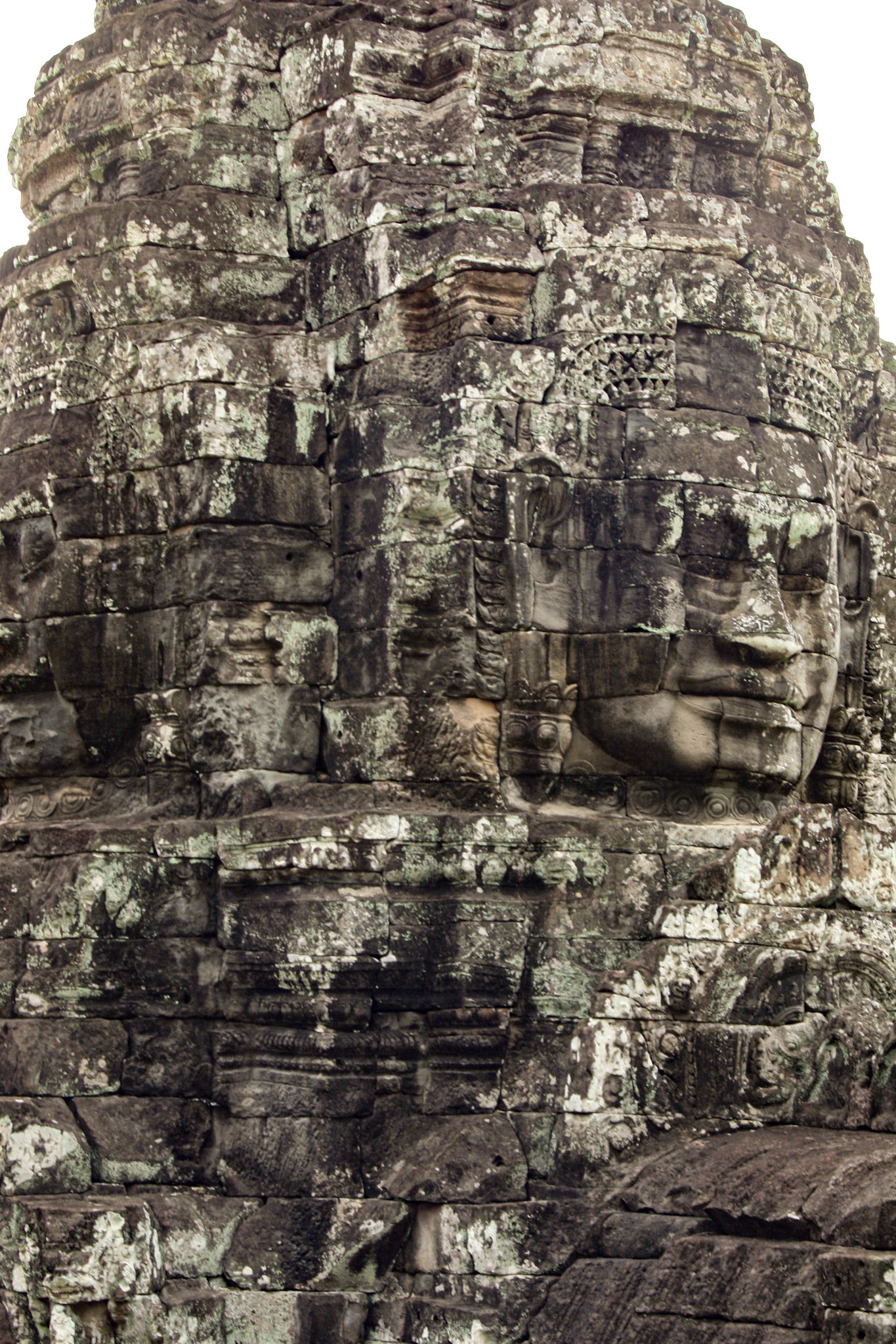 The Bayon's most distinctive feature is the multitude of serene and smiling stone faces on the many towers which jut out from the upper terrace and cluster around its central peak. 