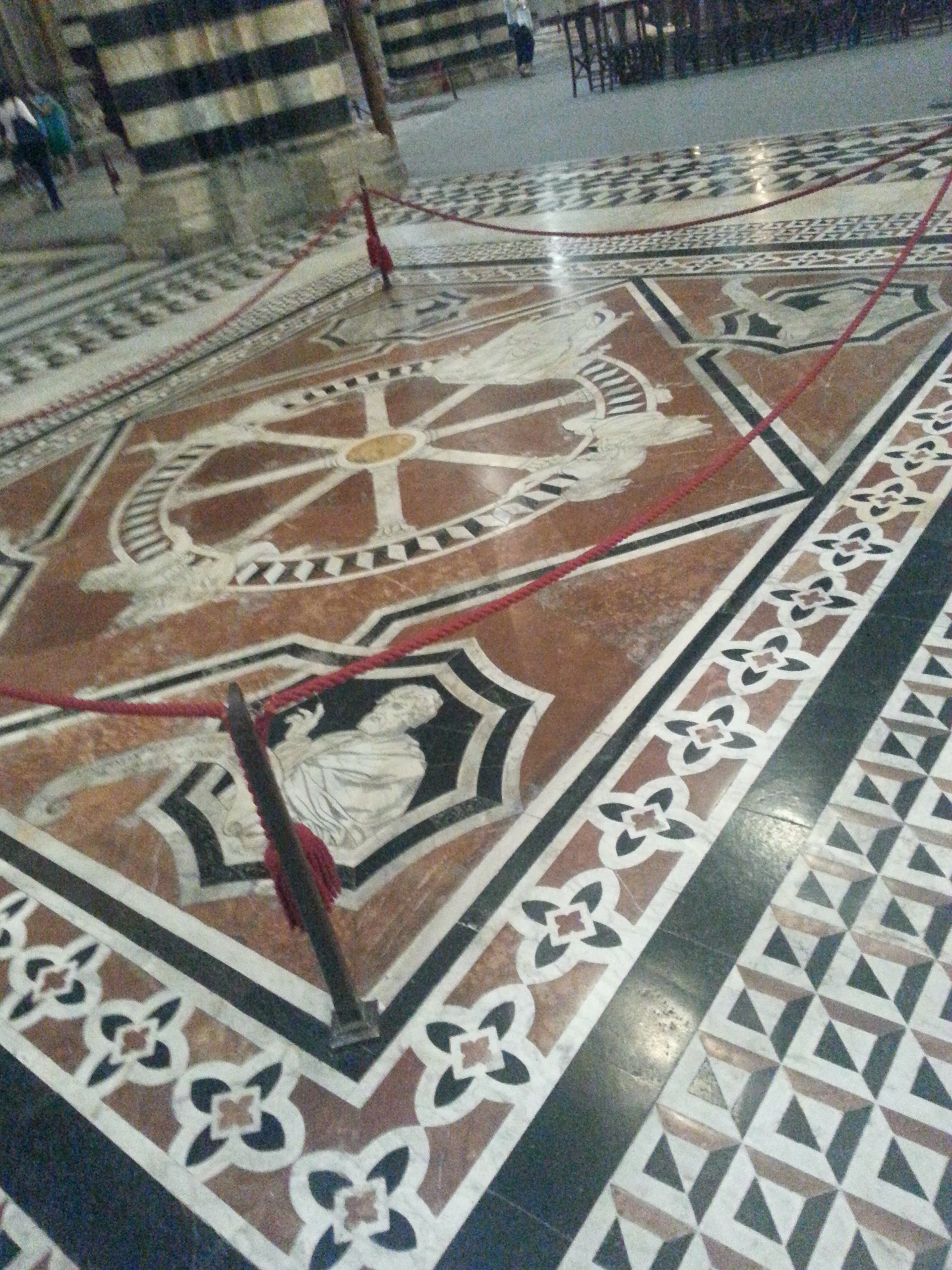    Details of the marble floor:  Ruota della Fortuna (“The Wheel of Fortune”) which communicates the mutability of fortune and is aimed at encouraging its viewers to turn to faith and work rather than relying on chance.