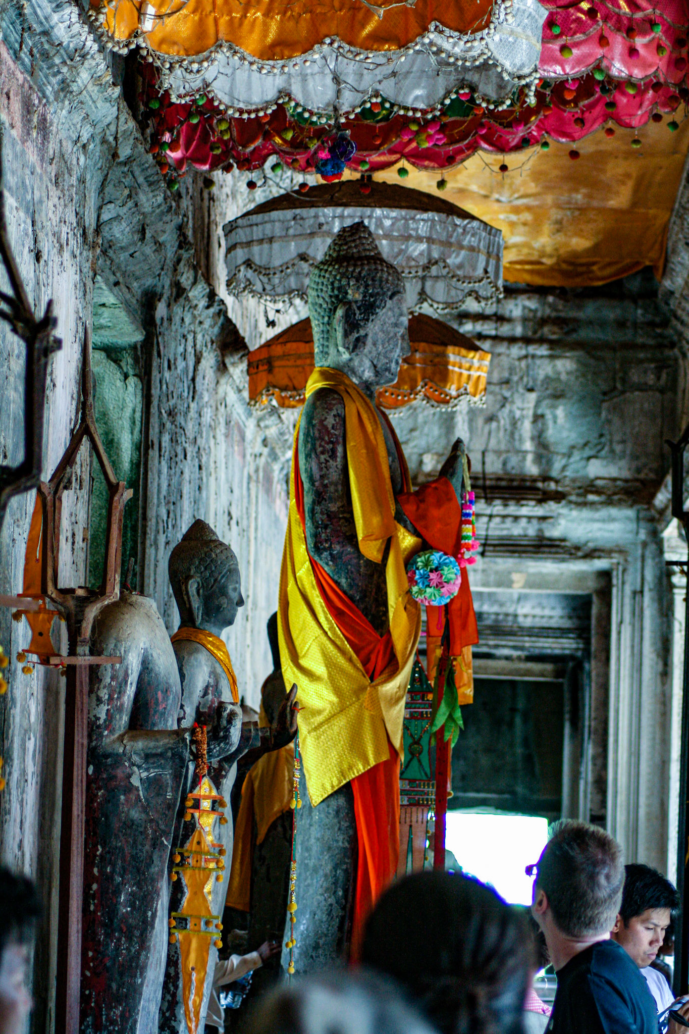 Buddhism proliferated in the Cambodian region during the 13th century. Gradually, it became the dominant religion of Cambodia and Angkor Wat, along with other Hindu monuments, were repurposed for Buddhist worship. Buddhist iconography was added alongside the existing Hindu symbols and sculptures of Buddha were erected. The temple continues to be used for Buddhist worship to this day. 