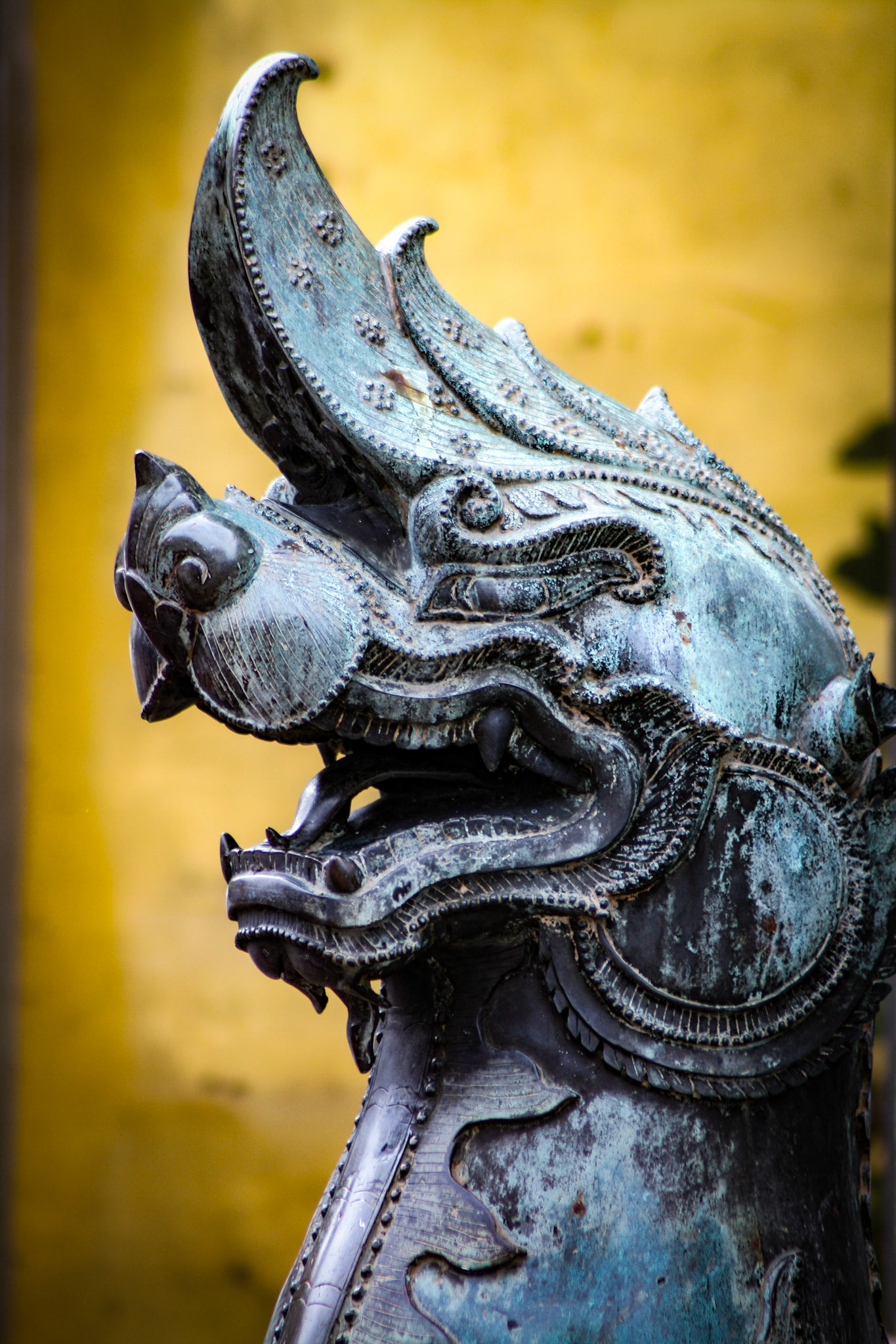 A bronze mythological lion guards the Ubosot