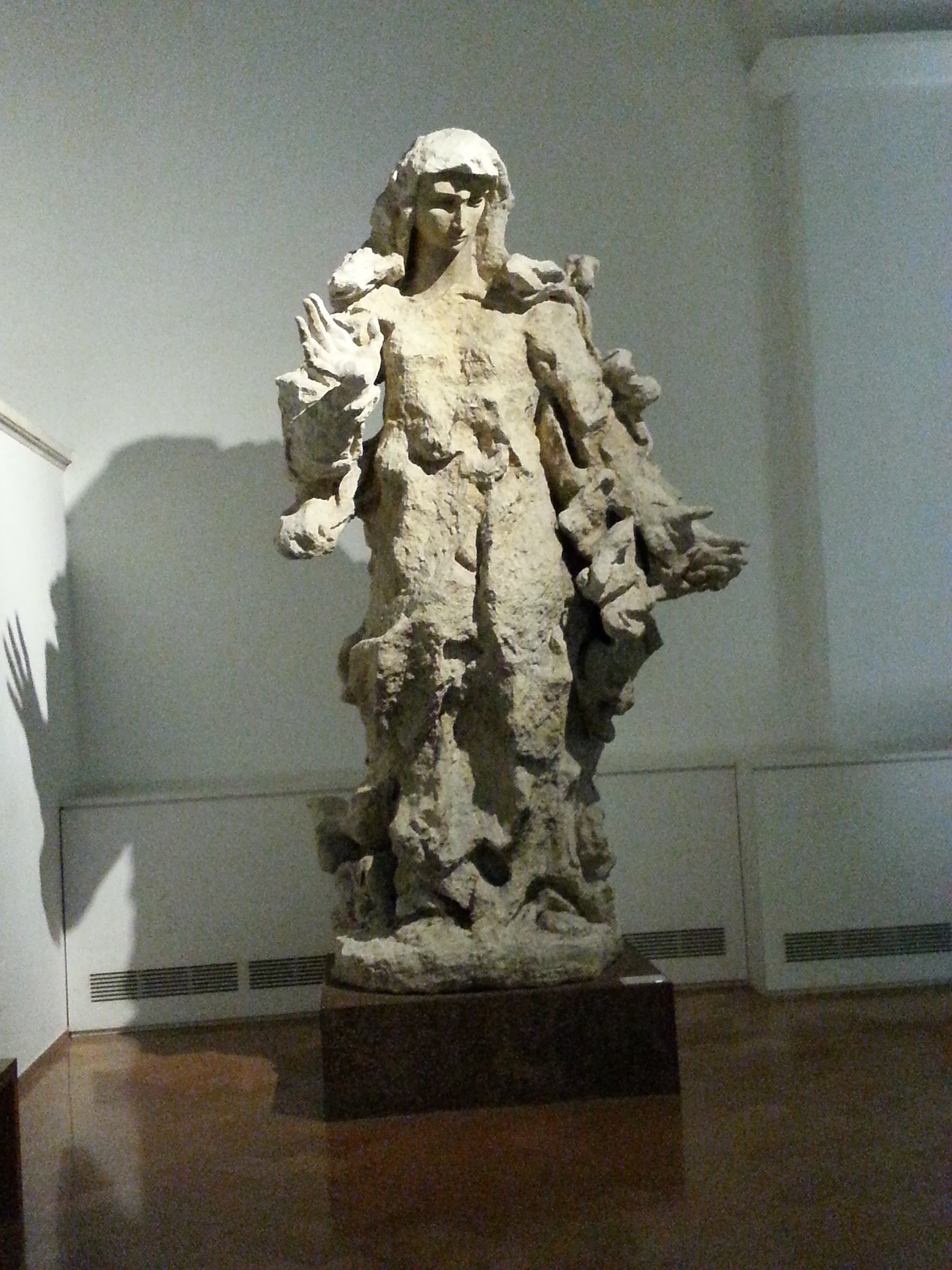 A Museum placard indicates that 1856 limestone sculpture is by Lucio Fontana. It is entitled "Madonna." 