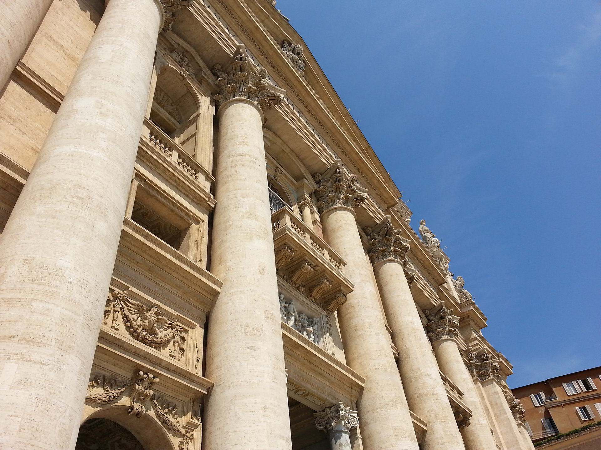 The center columns of the church, leading up to the Pope's balcony. St. Peter's square in front of St. Peter's Basilica at the Vatican. 