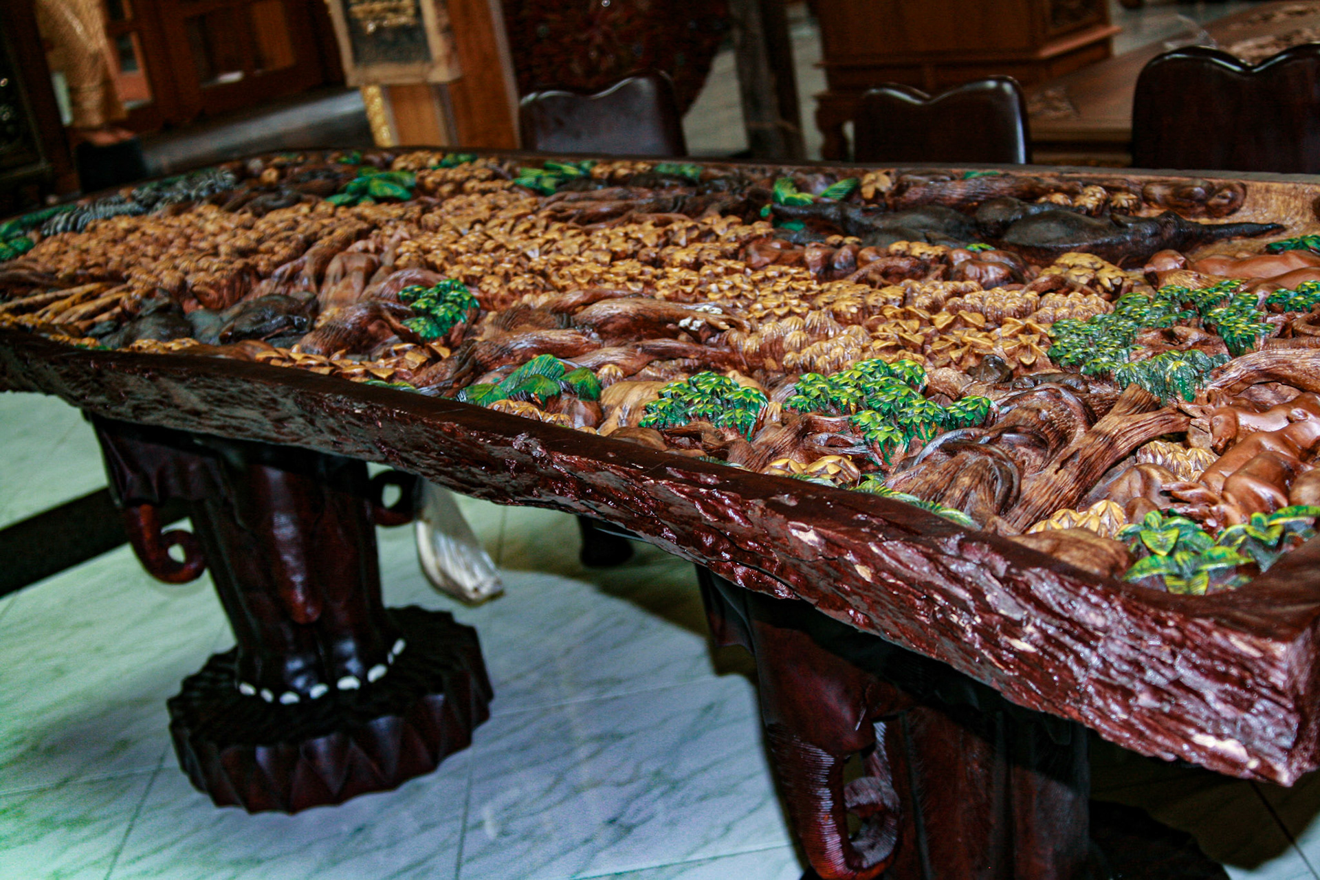 Wood carving on table at a Teakwood art factory.