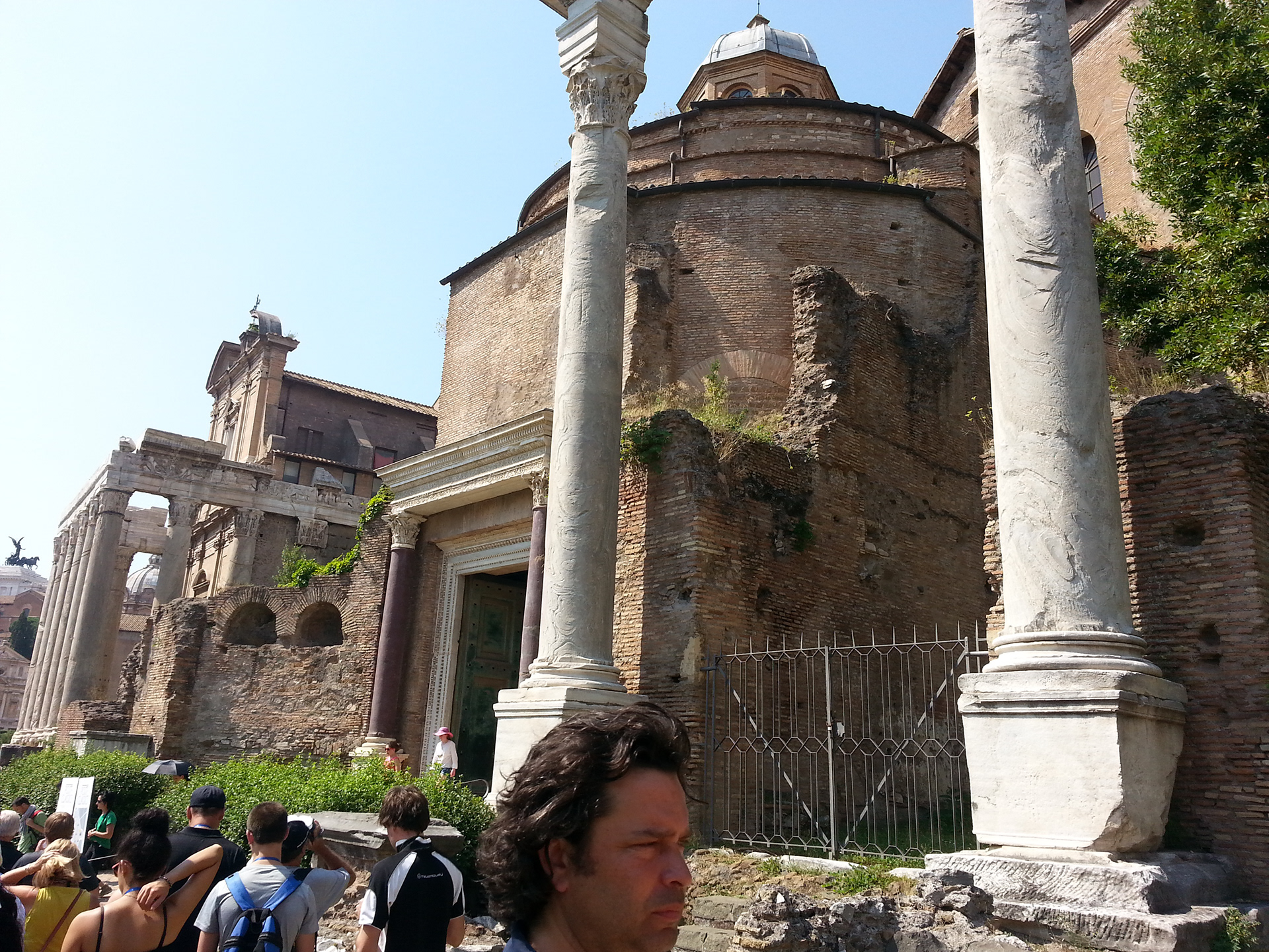 Set between two porphyry columns that support a reused marble architrave are the original bronze doors of the Temple of Divine Romulus, deified by his father Maxentius in AD 309, when the boy is presumed to have died. They open into a rotunda fifty Roman feet in diameter covered by a cupola, which now is accessible from the rear through the Basilica of Santi Cosma e Damiano. Early in the sixth century, the temple was converted into a vestibule for the church, which also occupied the southwest corner of the Temple of Peace, the first buildings in the forums to be Christianized. 