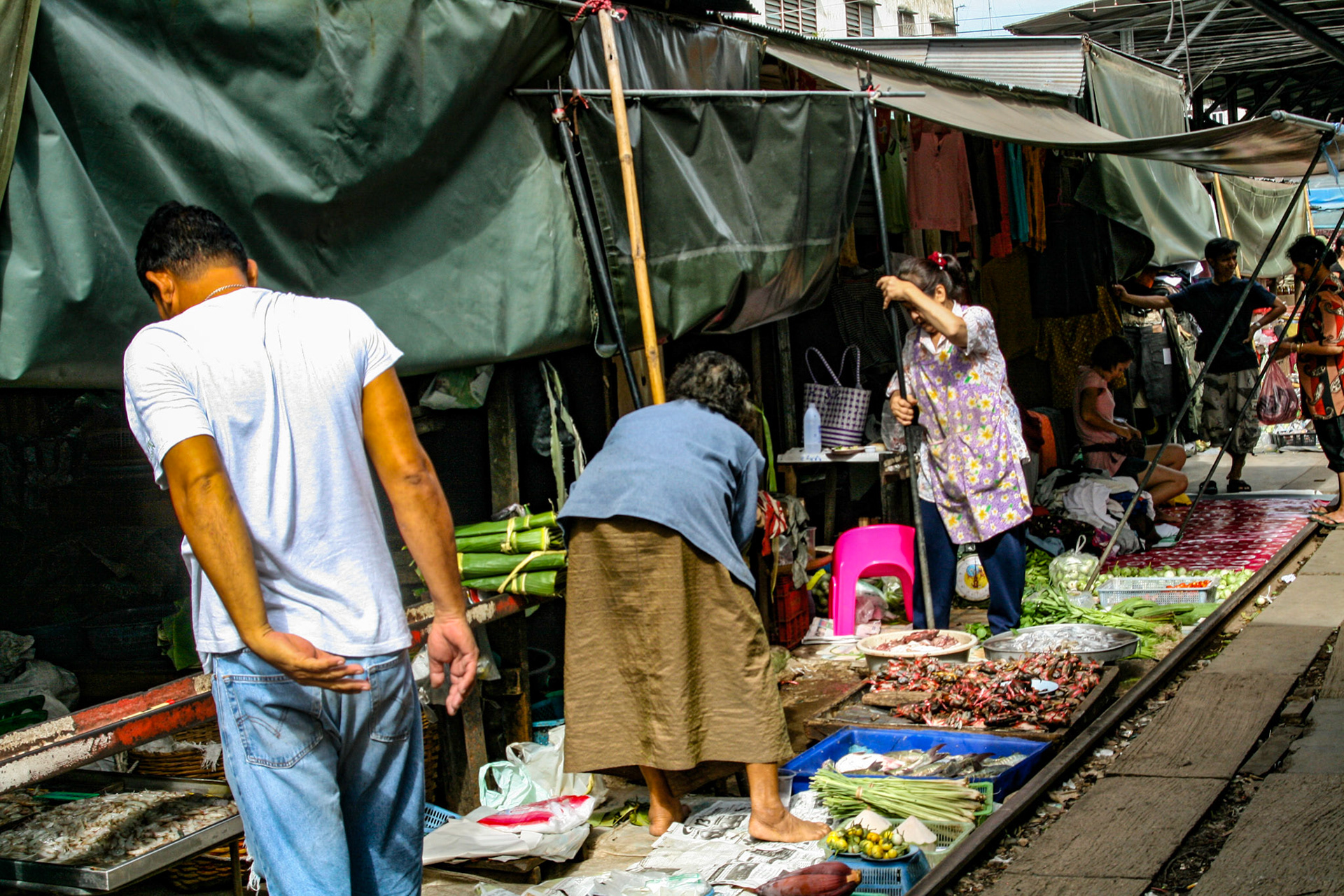 The tracks, which run right through the middle of the market are shielded in shade by large awnings suspended overhead by long poles.