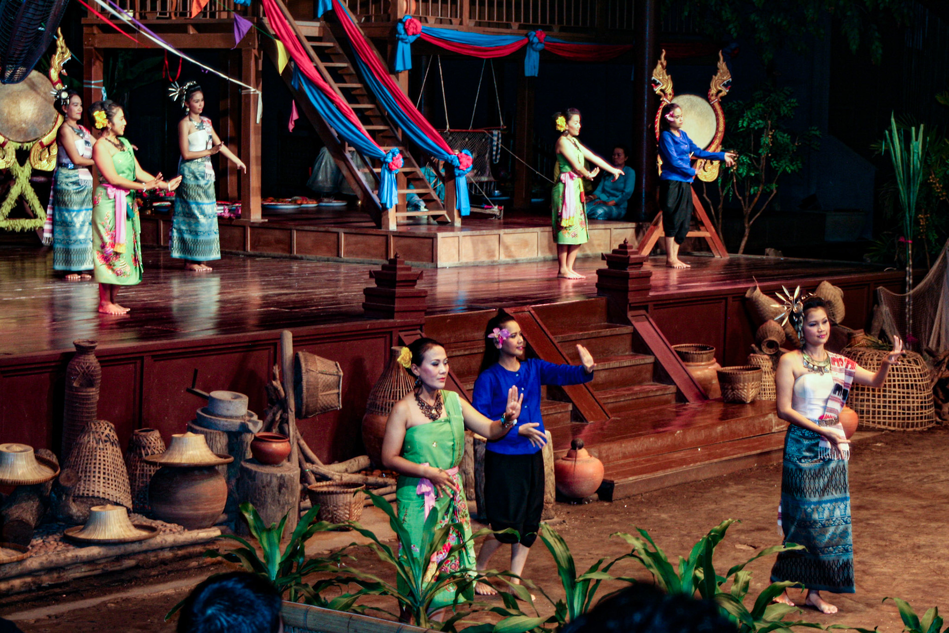 Thai men and women perform the energetic Bamboo Dance of northeastern Thailand at the Rose Garden