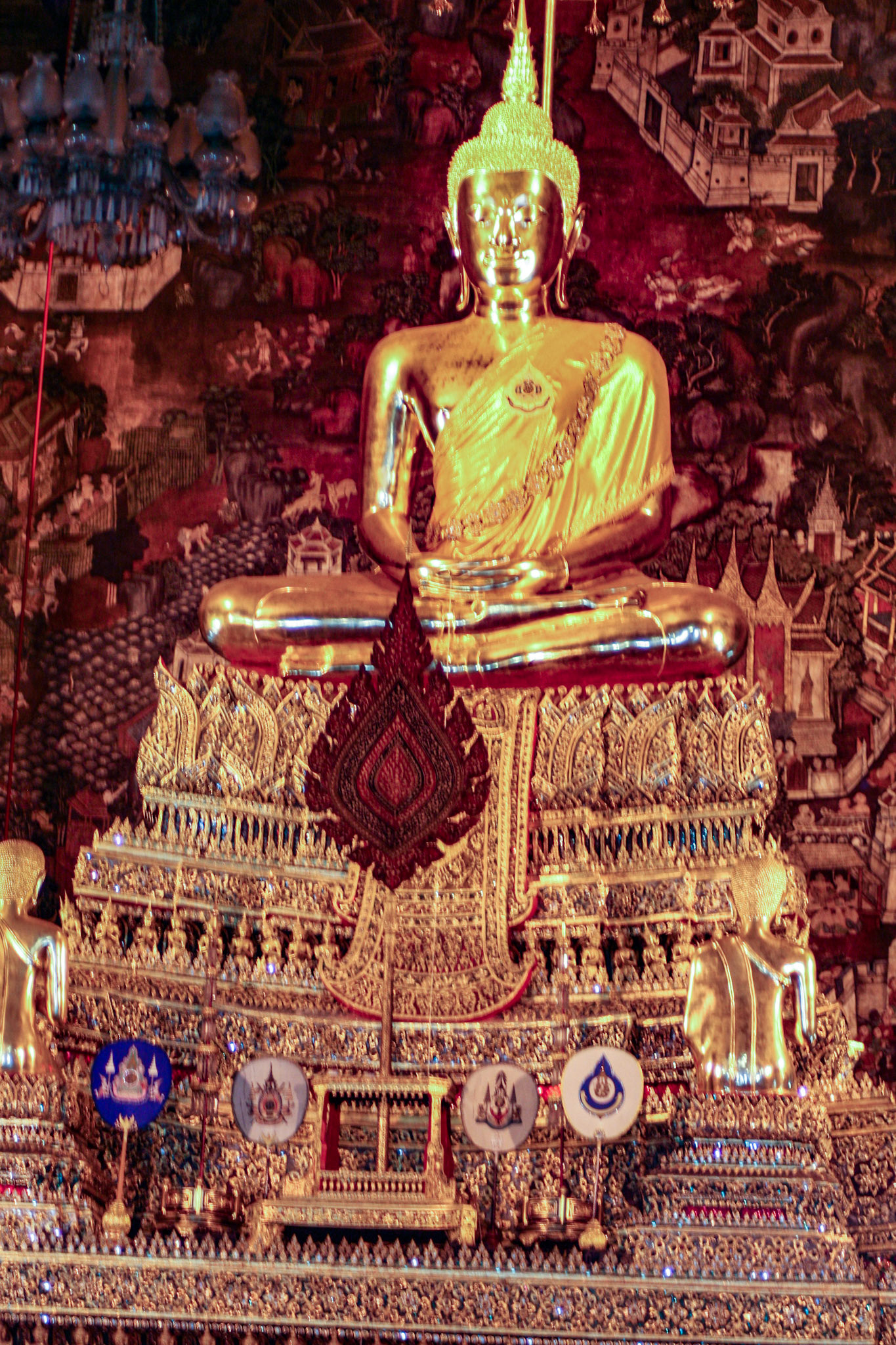 The Buddha in the ordination hall is the "Phra Buddha Deva Patimakorn" in a seated posture on a three tiered pedestal under which are some ashes of King Rama I.