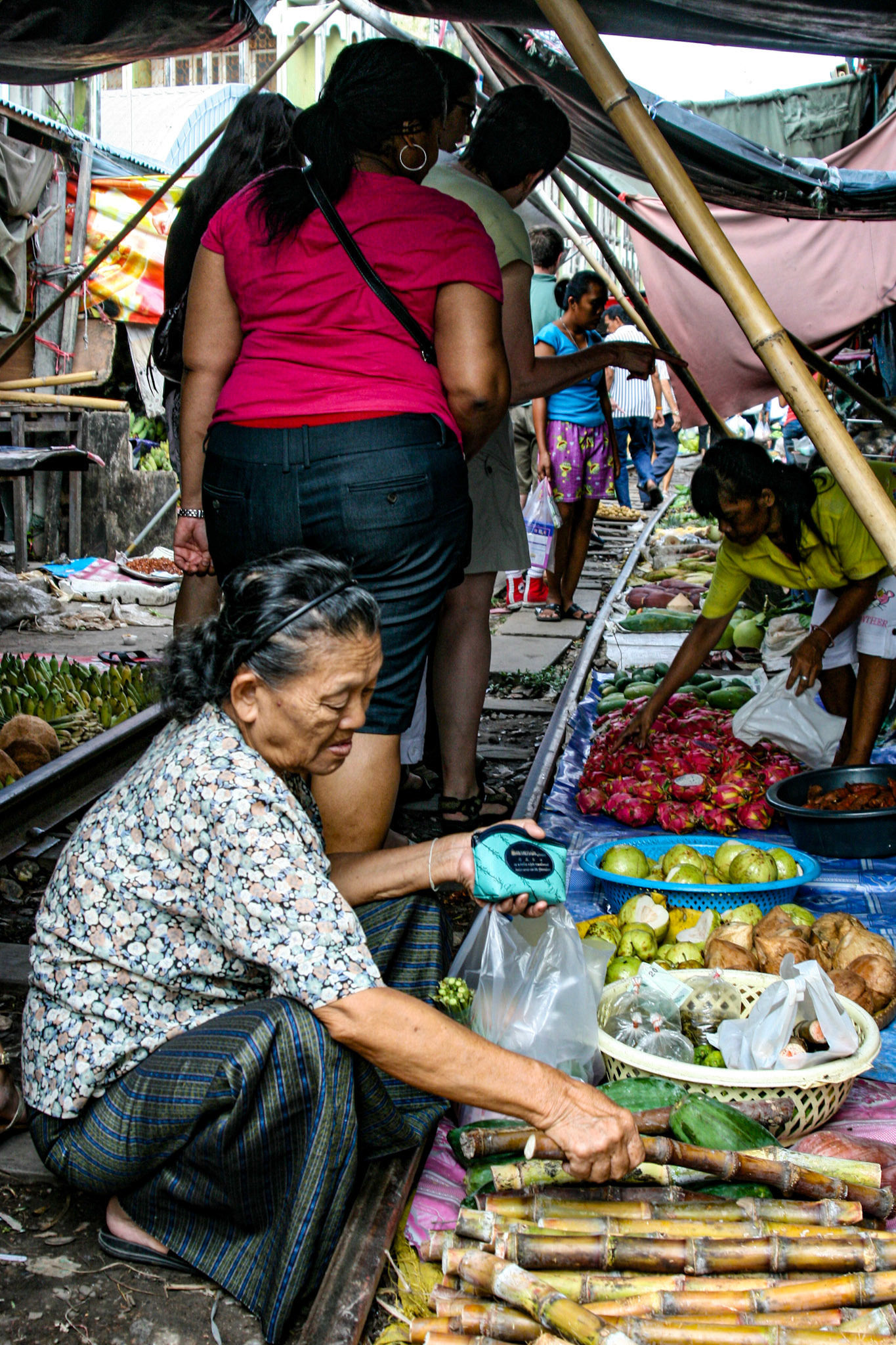 The tracks, which run right through the middle of the Maeklong Market are shielded in shade by large awnings suspended overhead by long poles.