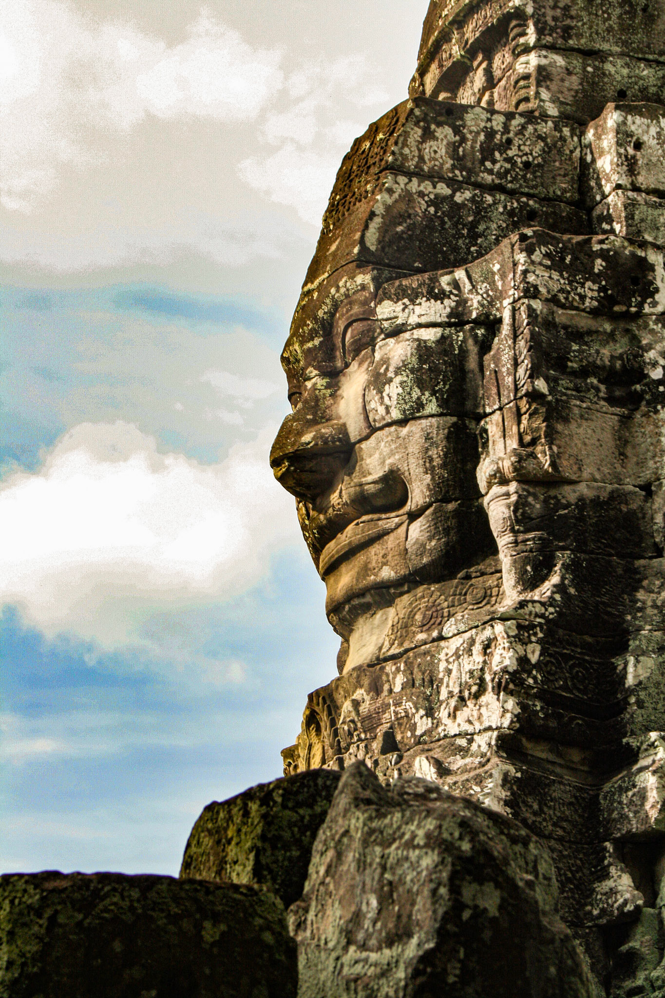 The Bayon's most distinctive feature is the multitude of serene and smiling stone faces on the many towers which jut out from the upper terrace and cluster around its central peak. 
