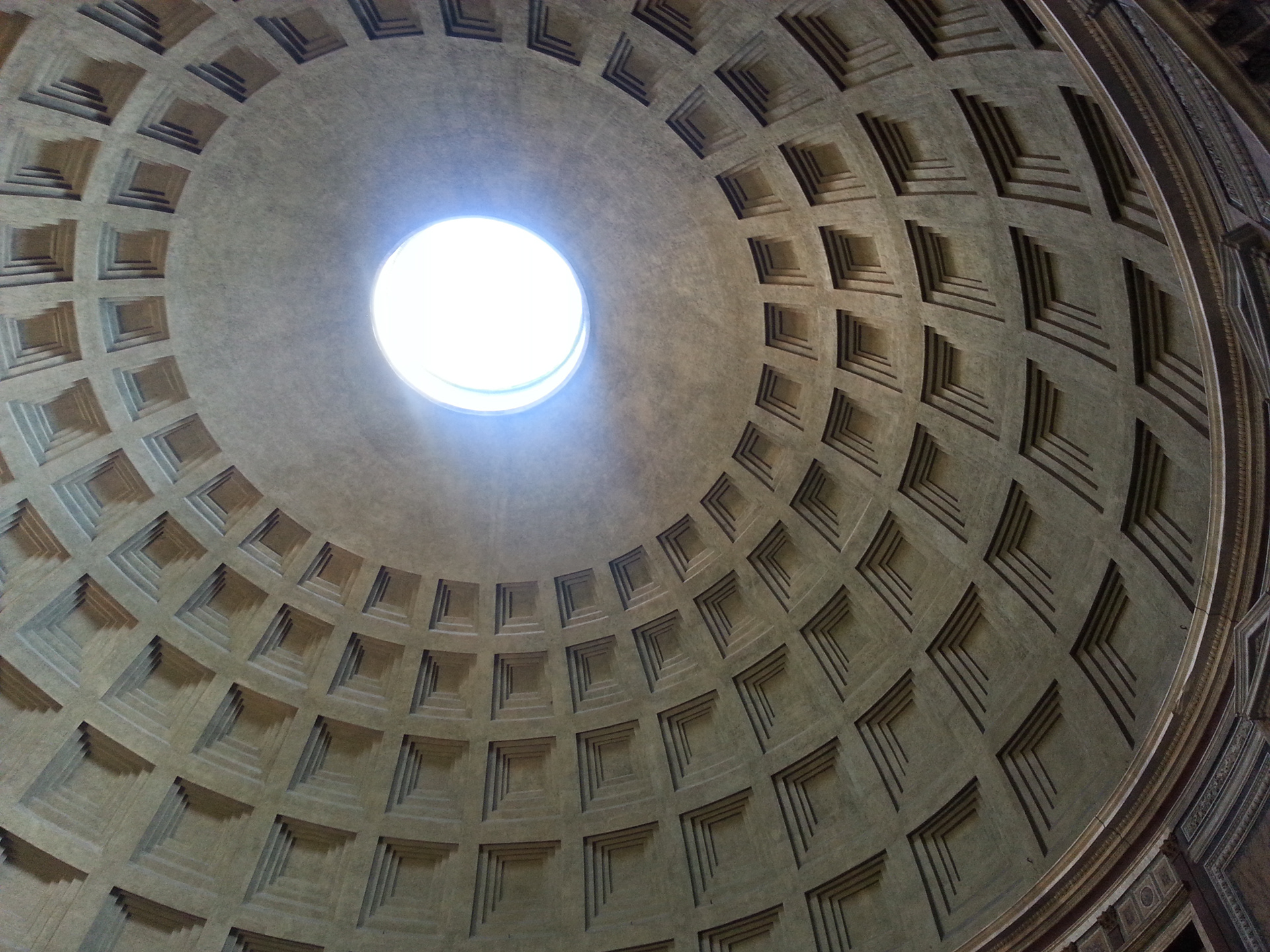 The building is cylindrical with a portico of large granite Corinthian columns (eight in the first rank and two groups of four behind) under a pediment. A rectangular vestibule links the porch to the rotunda, which is under a coffered concrete dome, with a central opening (oculus) to the sky. 