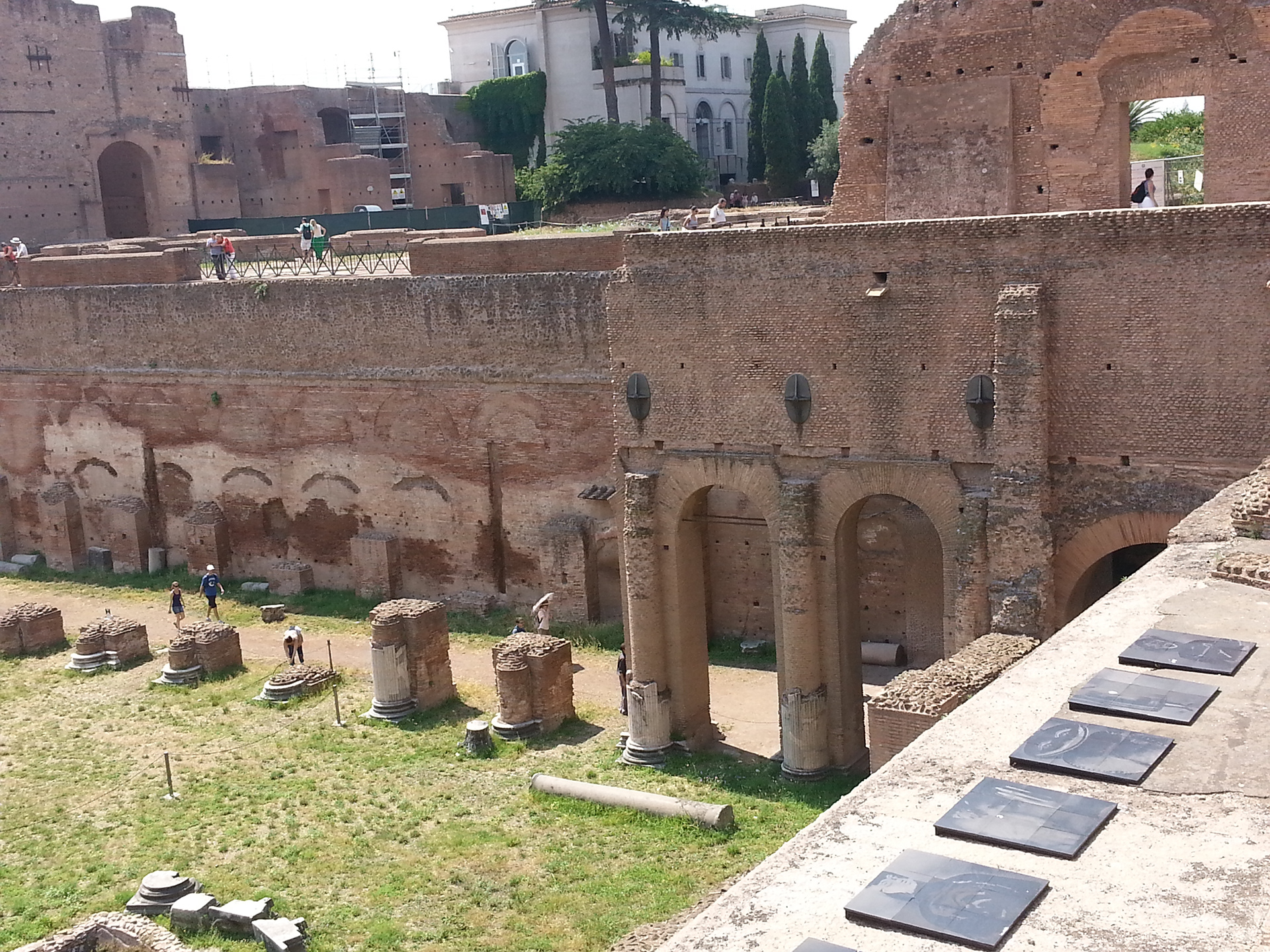 The Palatine Stadium was the third part of Domitian's palace on the Palatine Hill in Rome. It was the last to be built, after the Domus Flavia and the Domus Augustana, respectively the public and private parts of the complex. The stadium was a circus -shaped building, with a very elongated rectangle with a curved shorter side (the southern one) of about 160 x 48 meters. It occupies the entire eastern side of the Domus Augustana, for a total of about 88 meters. The perimeter was decorated by a two-story portico, composed on the lower level by brick pillars covered with marble (only the bases remain) and on the upper level by marble columns, as can be seen in part in the reconstruction of the northern corner. 