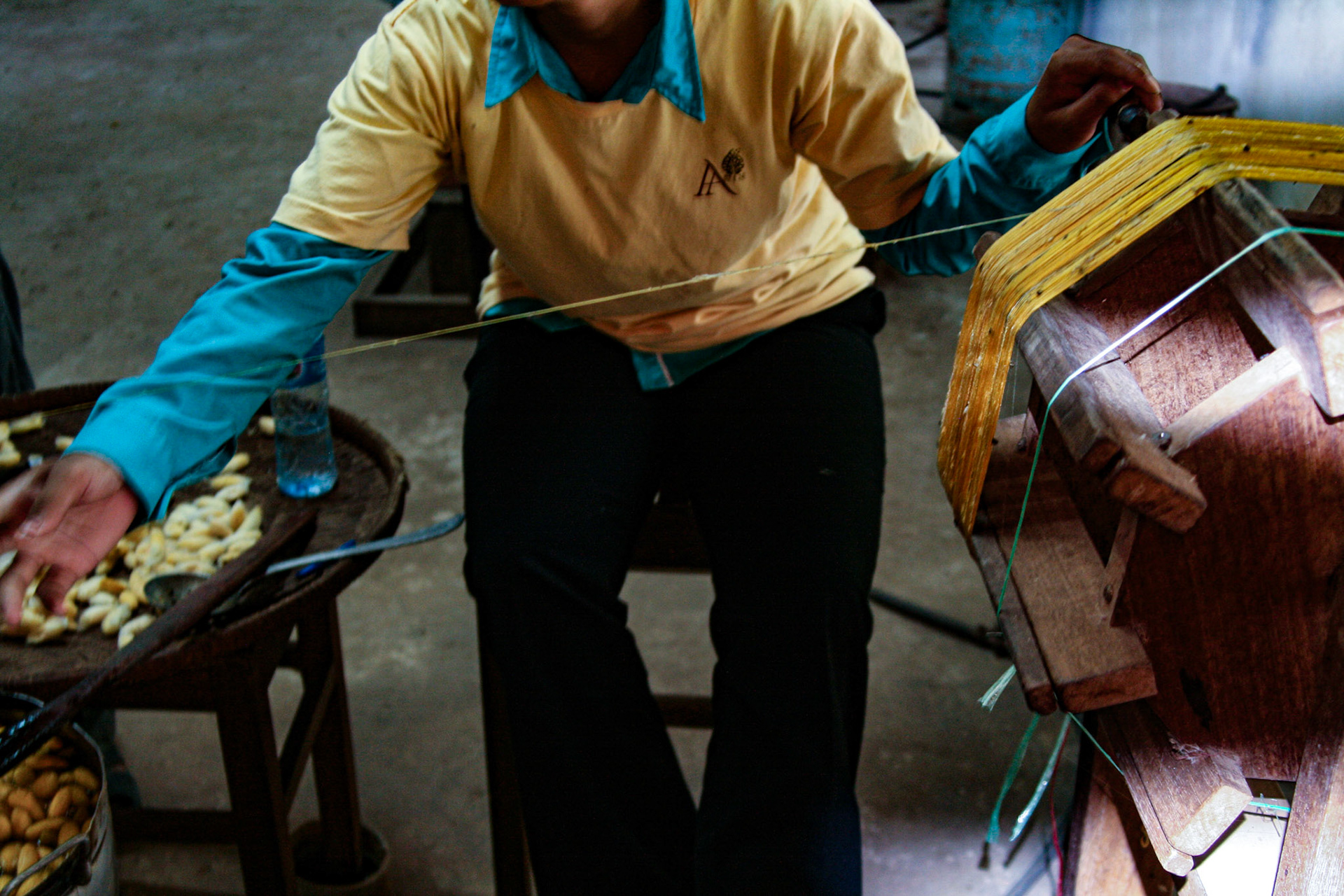 A silk worm factory. Extracting the thread from the cocoons.