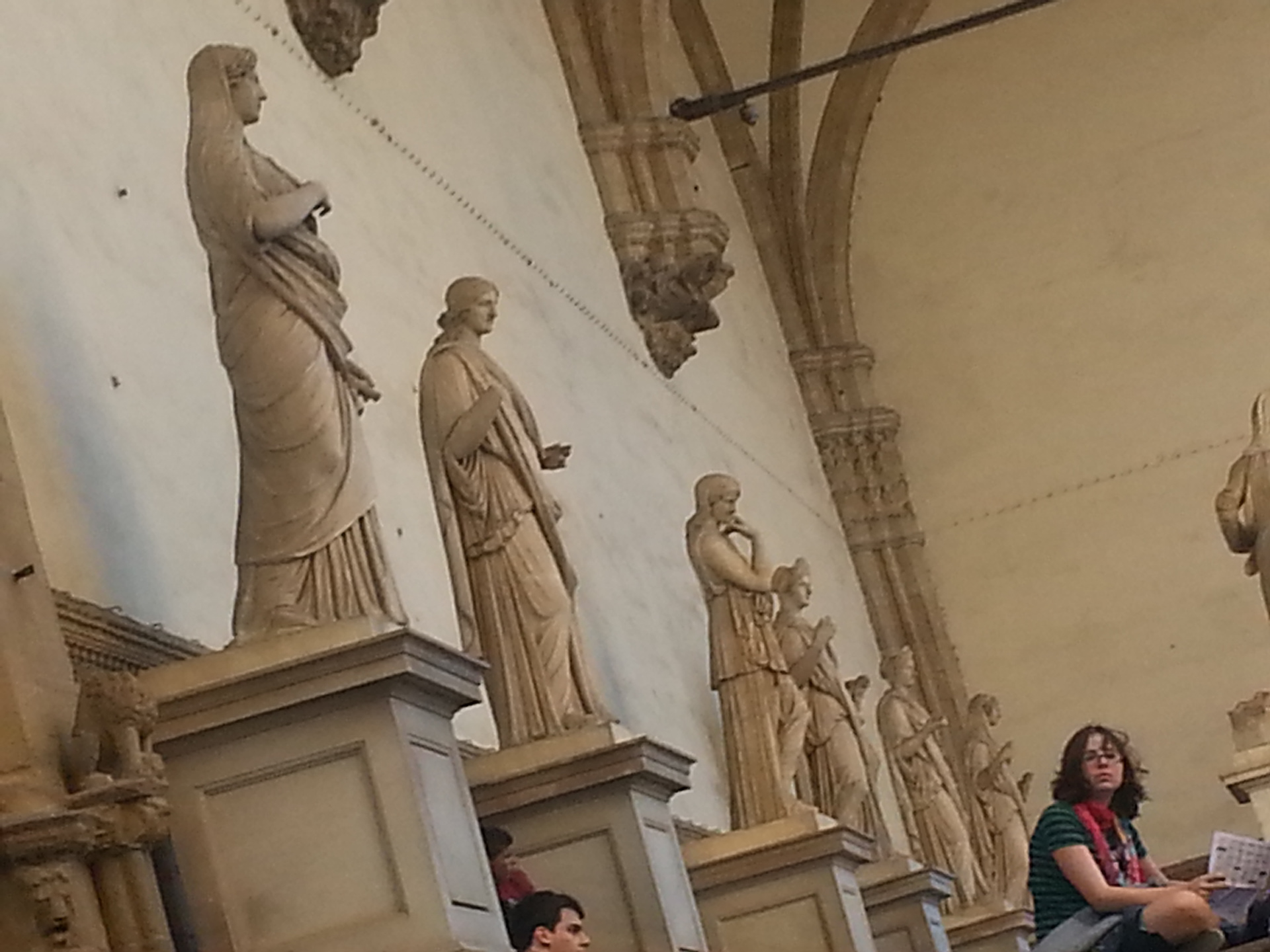 The graceful Loggia dei Lanzi, which sits to the right of Palazzo Vecchio and functions as an open-air sculpture gallery.