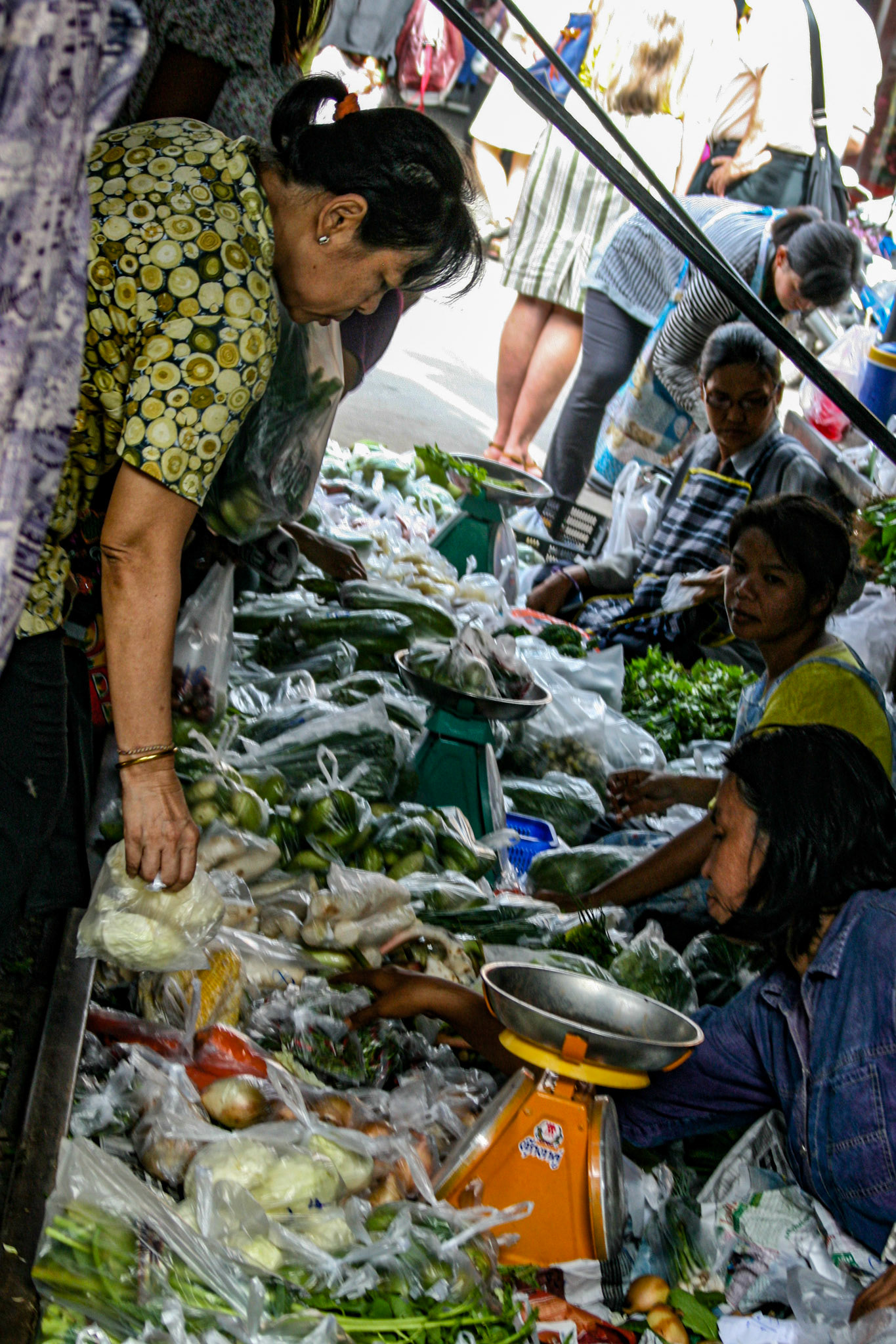 Shoppers make their way through and around the various vendors picking up whatever is needed for the day. 