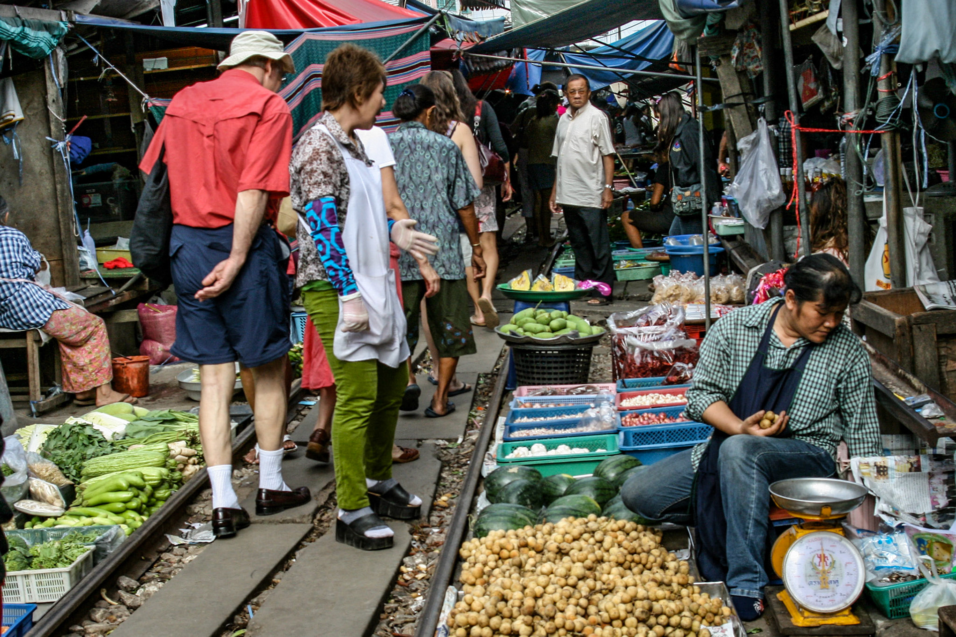 Shoppers make their way through and around the various vendors picking up whatever is needed for the day. 