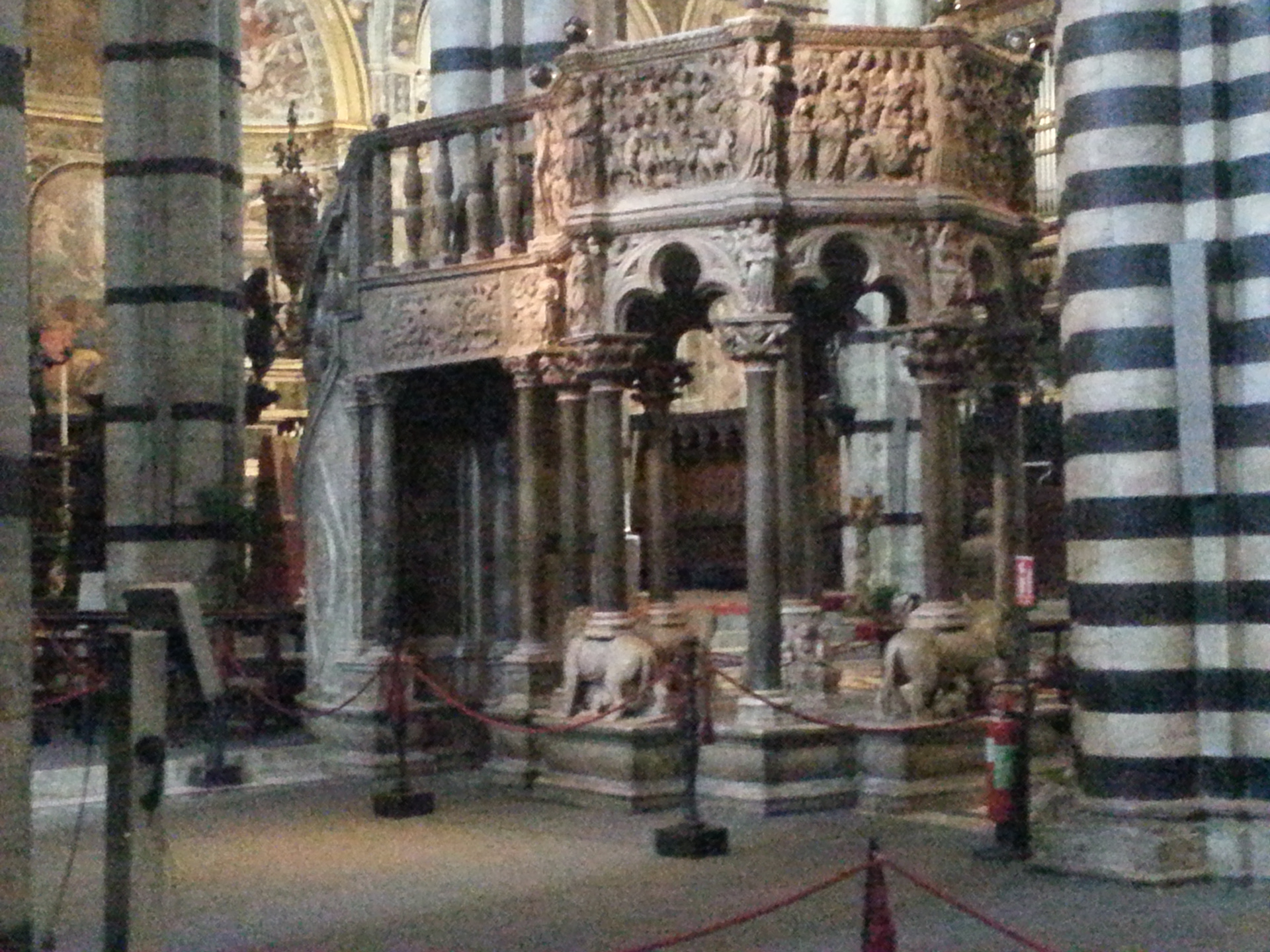 The Siena Cathedral Pulpit is an octagonal structure in Siena Cathedral sculpted by Nicola Pisano and his assistants Arnolfo di Cambio, Lapo di Ricevuto, and Nicolas' son Giovanni Pisano between the fall of 1265 and the fall of 1268. The pulpit, with its seven narrative panels and nine decorative columns carved out of Carrara marble, showcases Nicola Pisano's talent for integrating classical themes into Christian traditions, making both Nicola Pisano and the Siena pulpit forerunners of the classical revival of the Italian Renaissance. 
