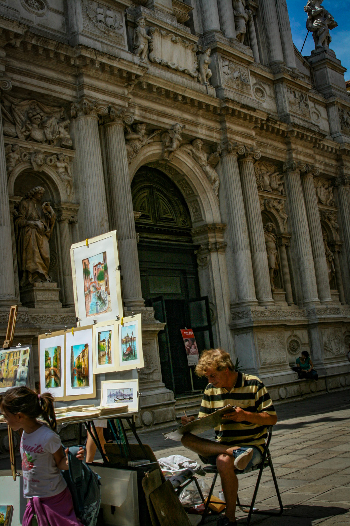 Artist selling paintings.