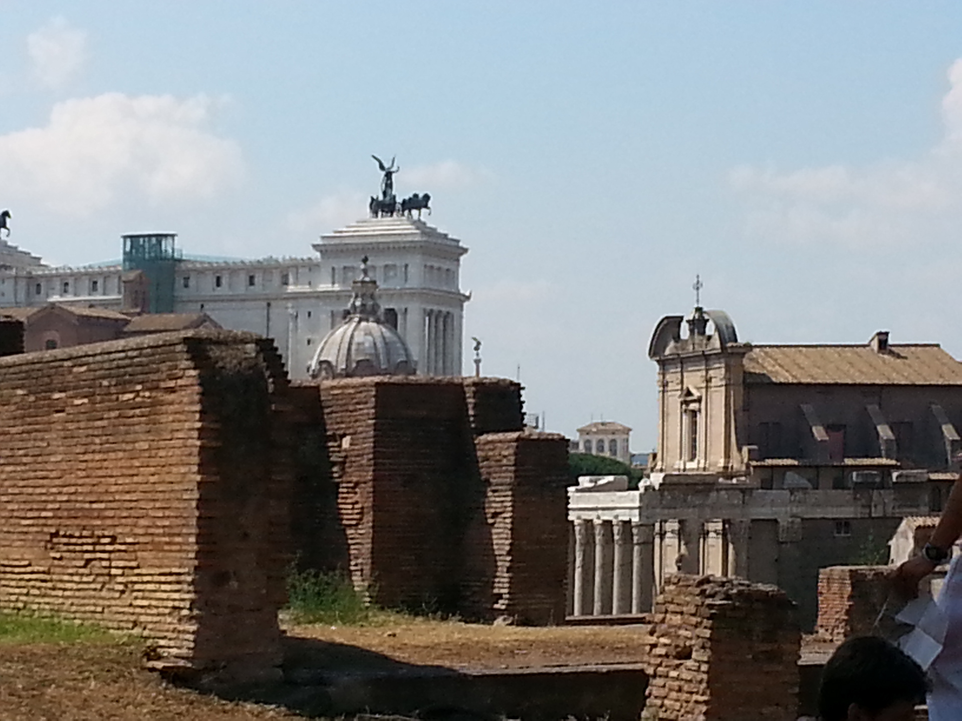 View from the forum of the war memorial monument in Rome. A gigantic building that screams power. It is called Vittorio Emanuele II monument and it was built in honor of the first world war. 
