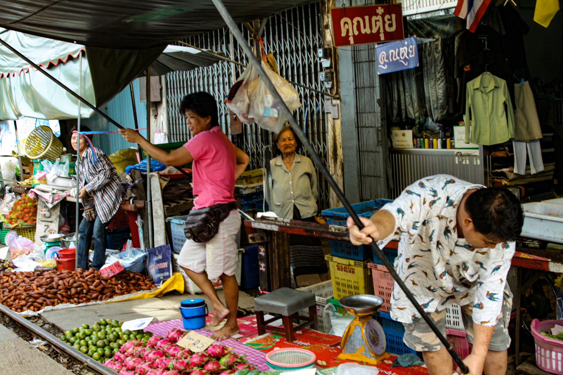 One minute you see the locals shopping for their vegetables and the next, vendors scoop up their baskets and boxes and anything that lies over the track.