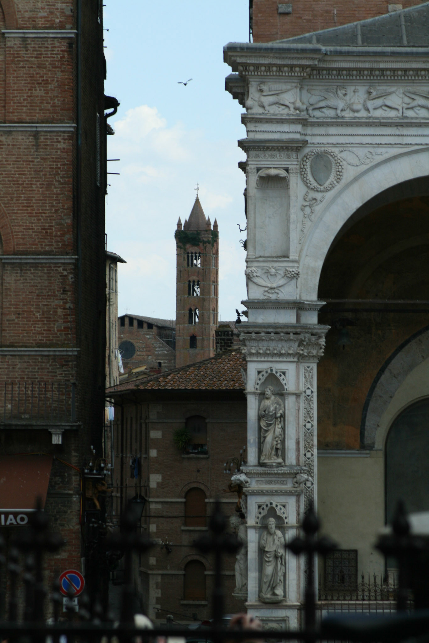 Distant shot of the bell tower forThe Church of Santa Maria dei Servi is a Romanesque style, Roman Catholic church in the Terzo of San Martino in the city of Siena, Tuscany, Italy.  