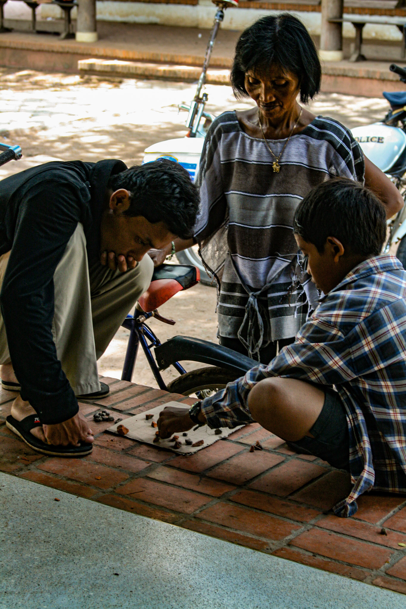 Locals playing a game with small stones.