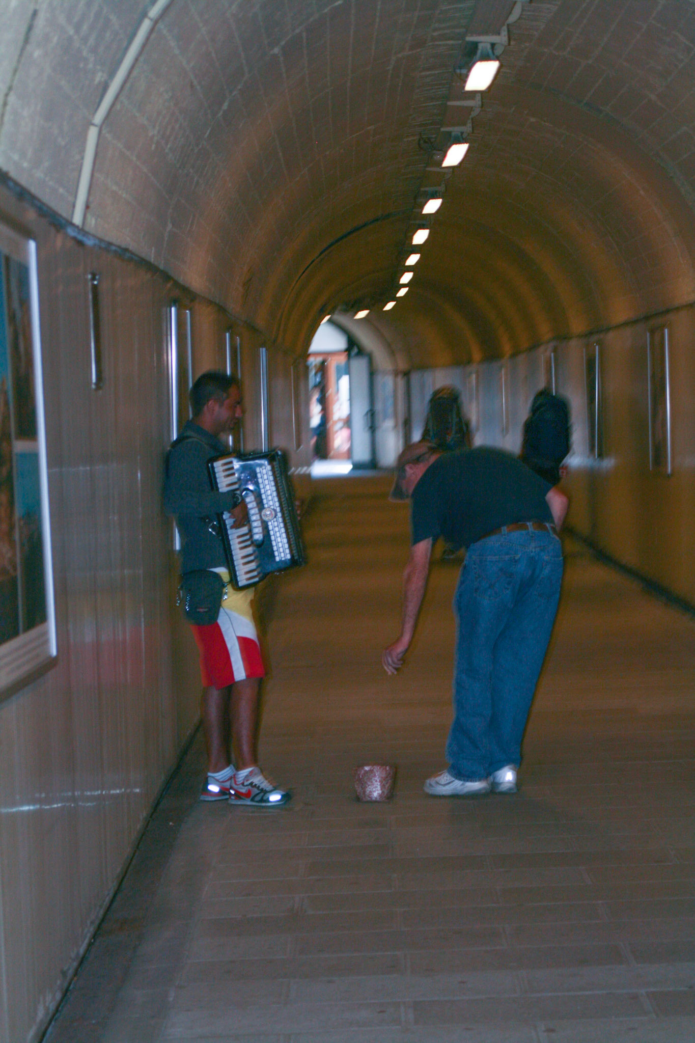 David Soileau stops to tip a musician serenading the crowd in the tunnel leading to the train station. Manarola is actually the second village of the Cinque Terre on the side of La Spezia. It is only 500 meters from the first village. The station is also separated from the town by a tunnel, now it is much more spacious and beautifully designed inside. 