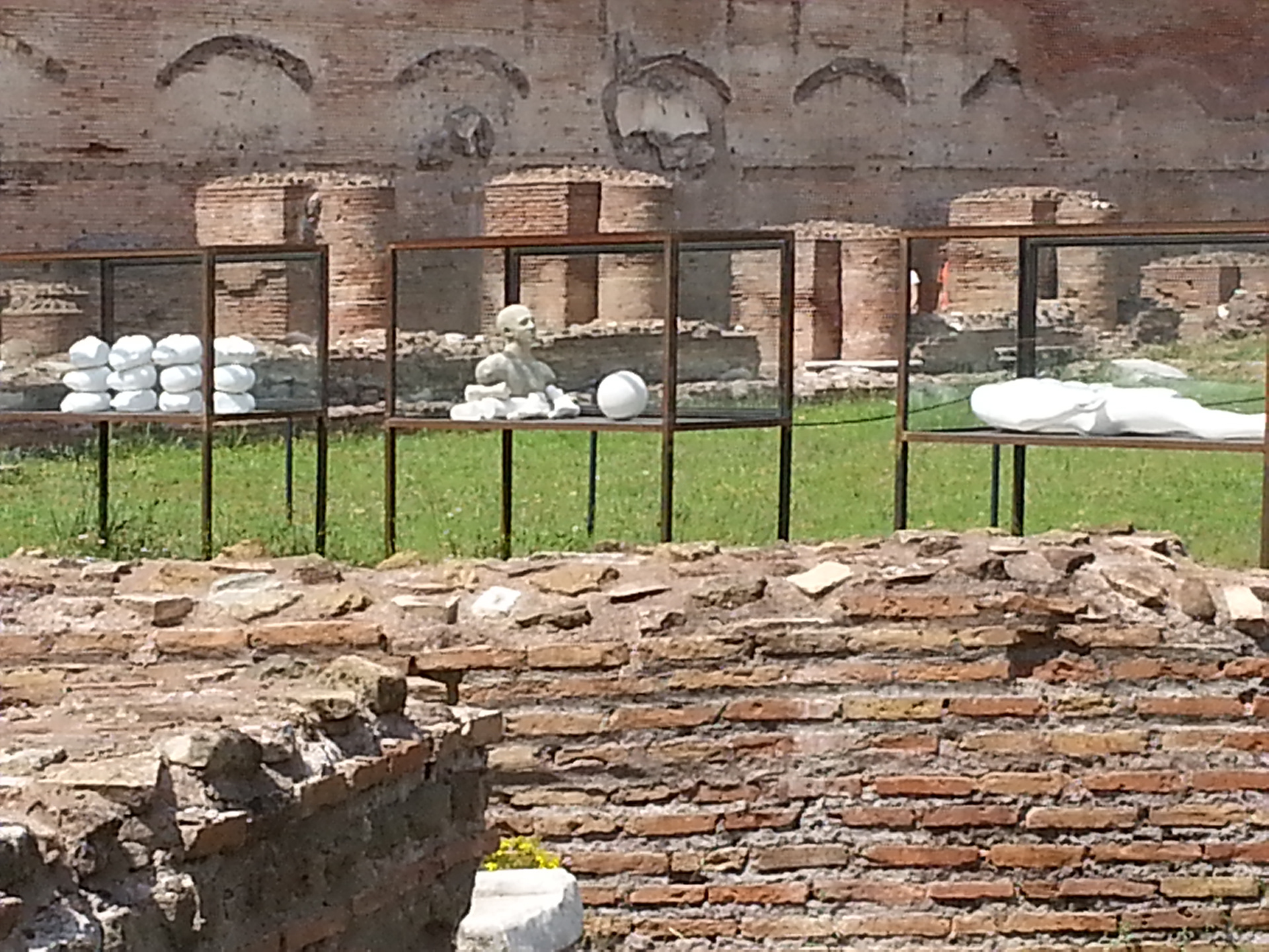 The Palatine Stadium was the third part of Domitian's palace on the Palatine Hill in Rome. It was the last to be built, after the Domus Flavia and the Domus Augustana, respectively the public and private parts of the complex. The stadium was a circus -shaped building, with a very elongated rectangle with a curved shorter side (the southern one) of about 160 x 48 meters. It occupies the entire eastern side of the Domus Augustana, for a total of about 88 meters. The perimeter was decorated by a two-story portico, composed on the lower level by brick pillars covered with marble (only the bases remain) and on the upper level by marble columns, as can be seen in part in the reconstruction of the northern corner. 