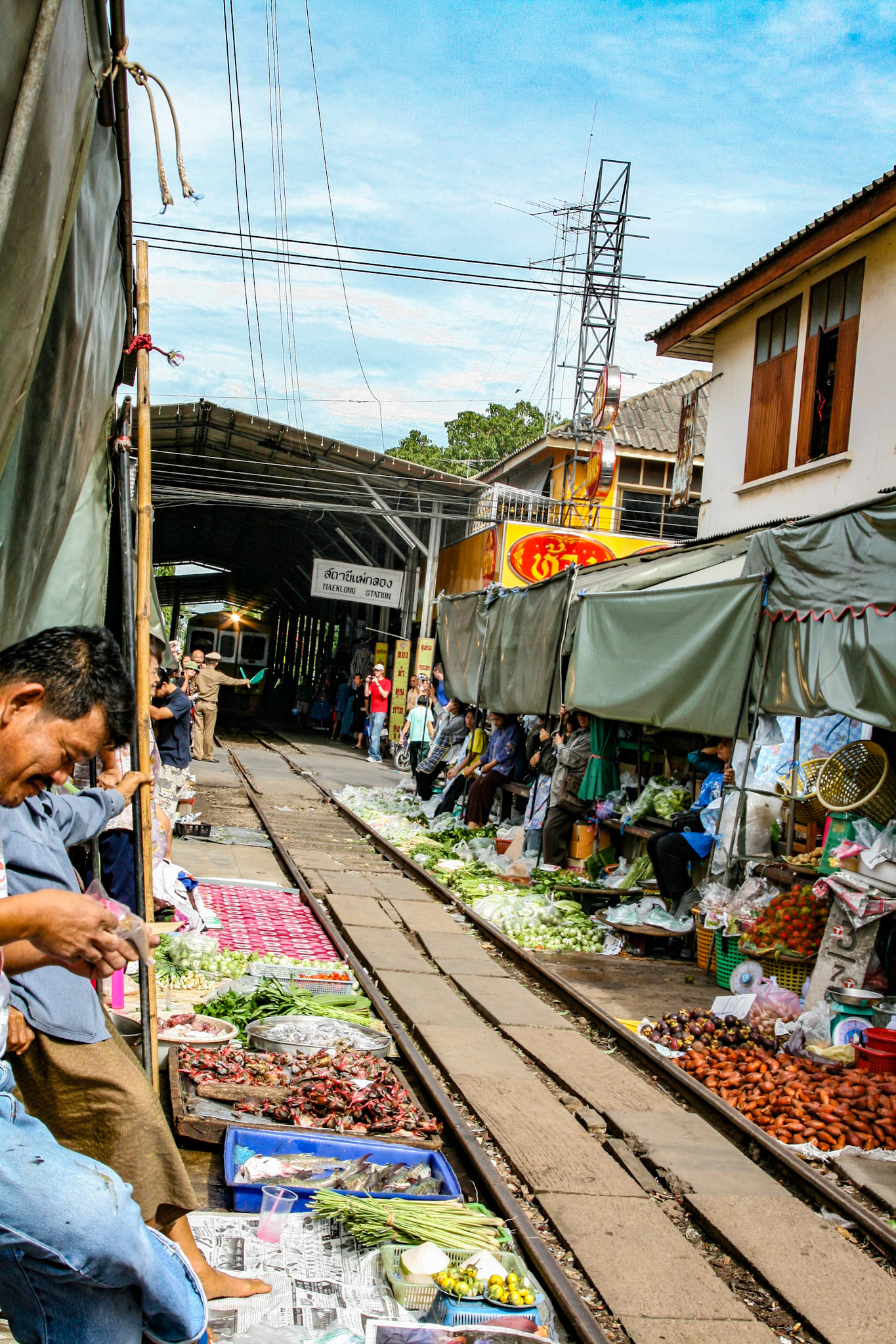 One minute you see the locals shopping for their vegetables and the next, vendors scoop up their baskets and boxes and anything that lies over the track.