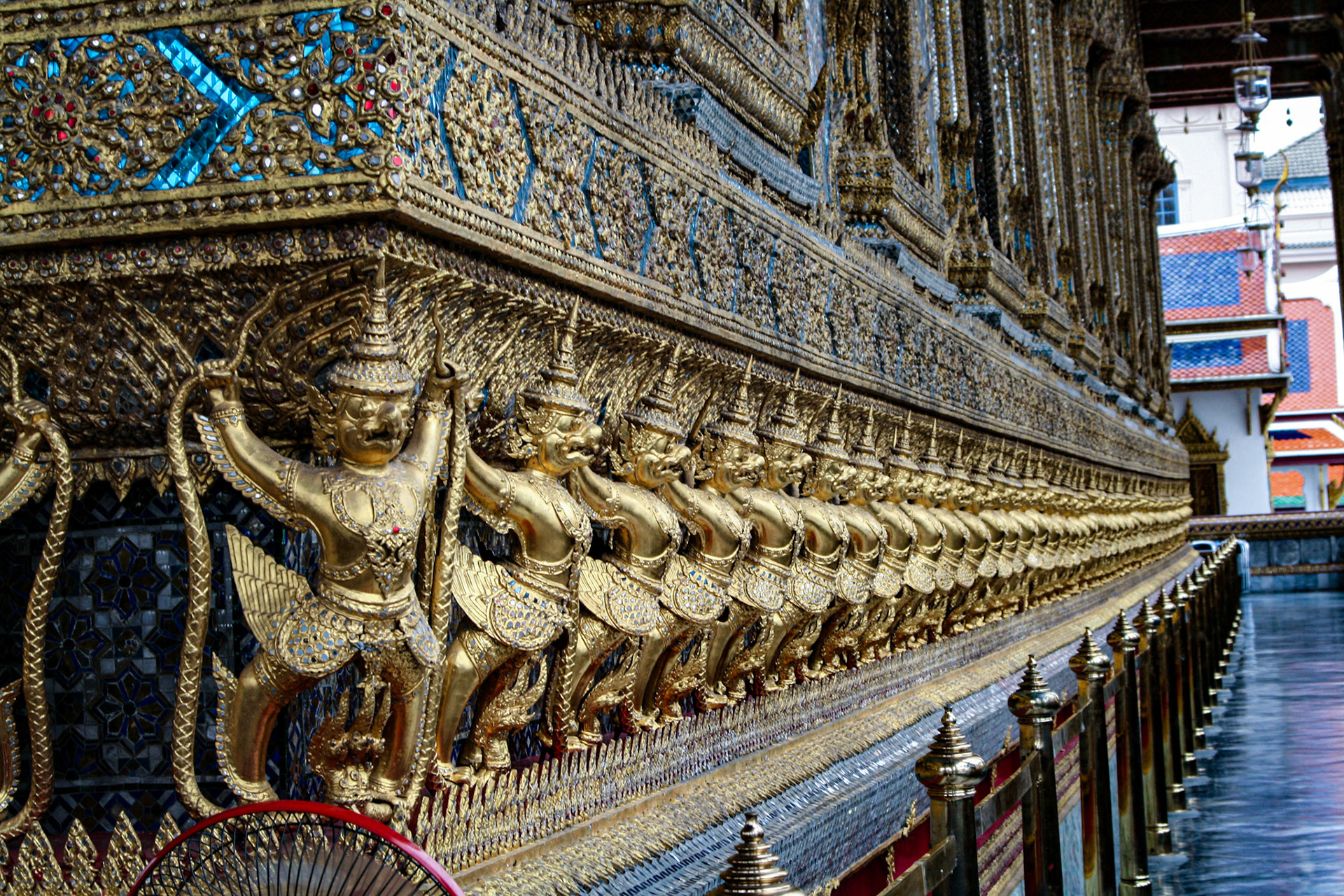 Golden garuda and naga statue, decoration on a wall of The Emerald Buddha temple, Wat Phra Kaew, Grand Palace, Bangkok, Thailand. 