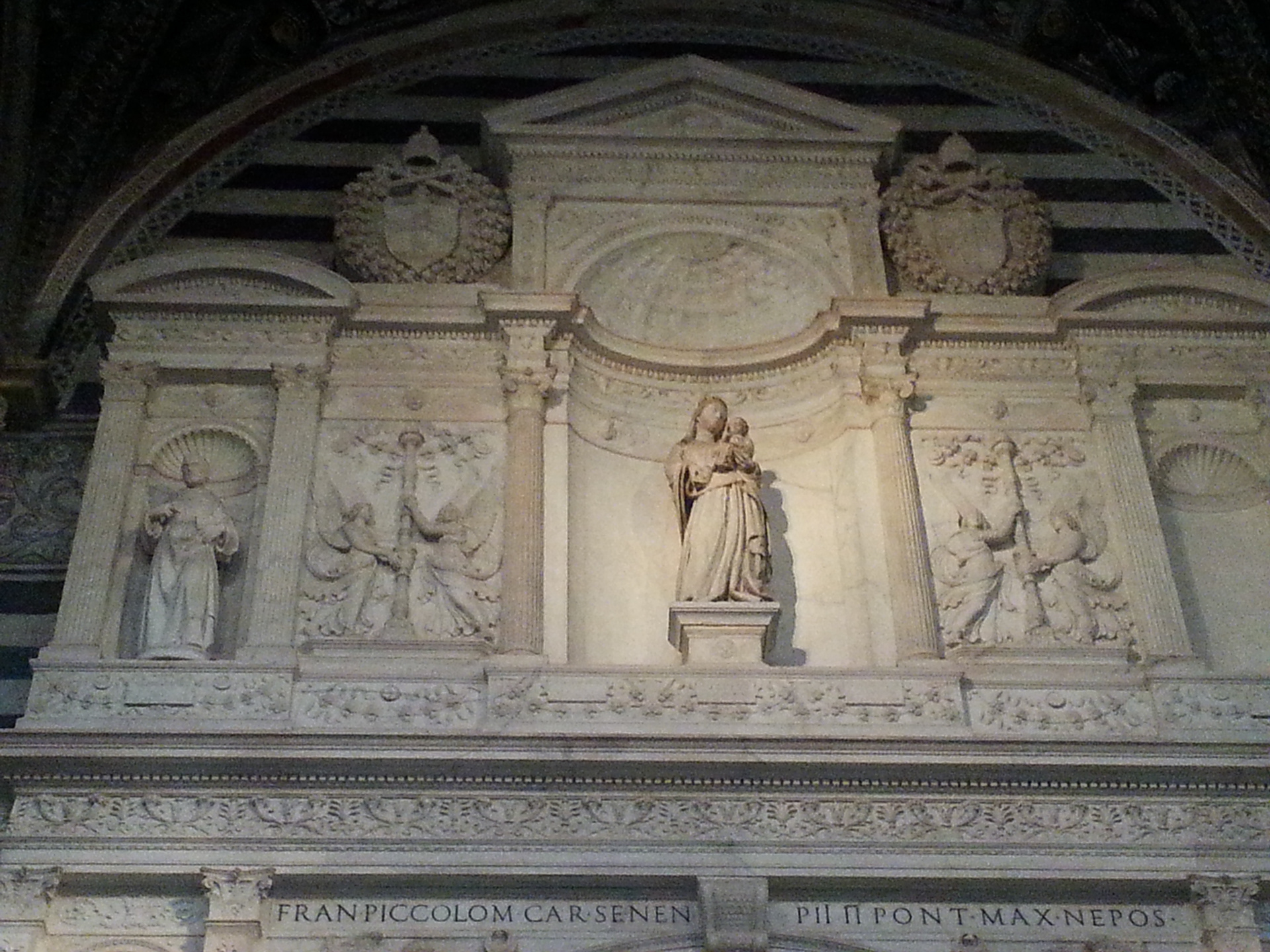 The Piccolomini Altar is an architectural and sculptural complex in the left aisle of Siena Cathedral, ordered by Cardinal Francesco Piccolomini Todeschini. It was built between 1481 and 1485 by Andrea Bregno in Carrara marble and decorated in the following decades. Michelangelo 's intervention stands out with the collaboration of four sculptures for some altar niches, between 1501 and 1504. 