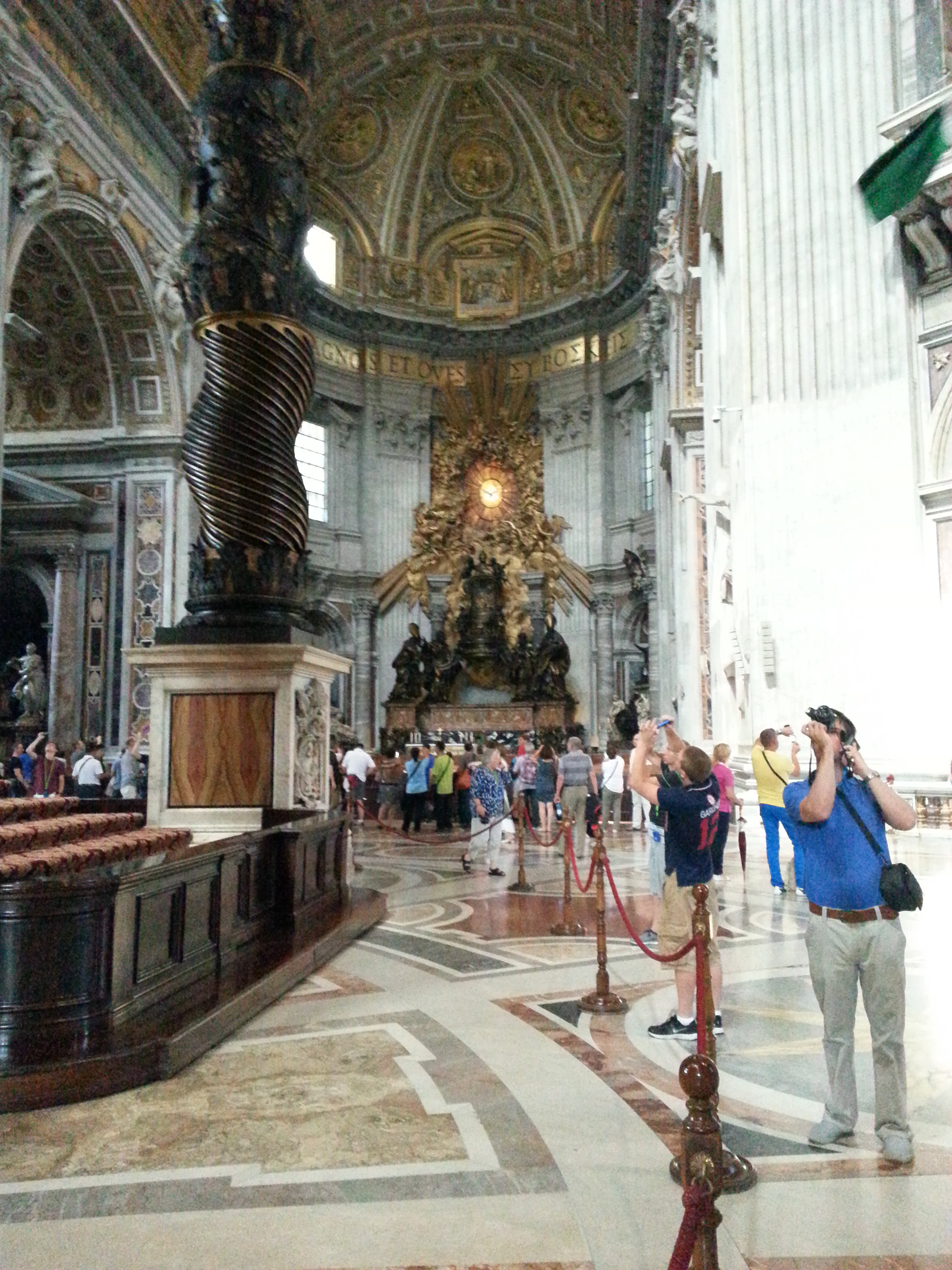 The baldachin acts as a visual focus within the basilica; it is itself a very large structure and forms a visual mediation between the enormous scale of the building and the human scale of the people officiating at the religious ceremonies at the papal altar beneath its canopy. 