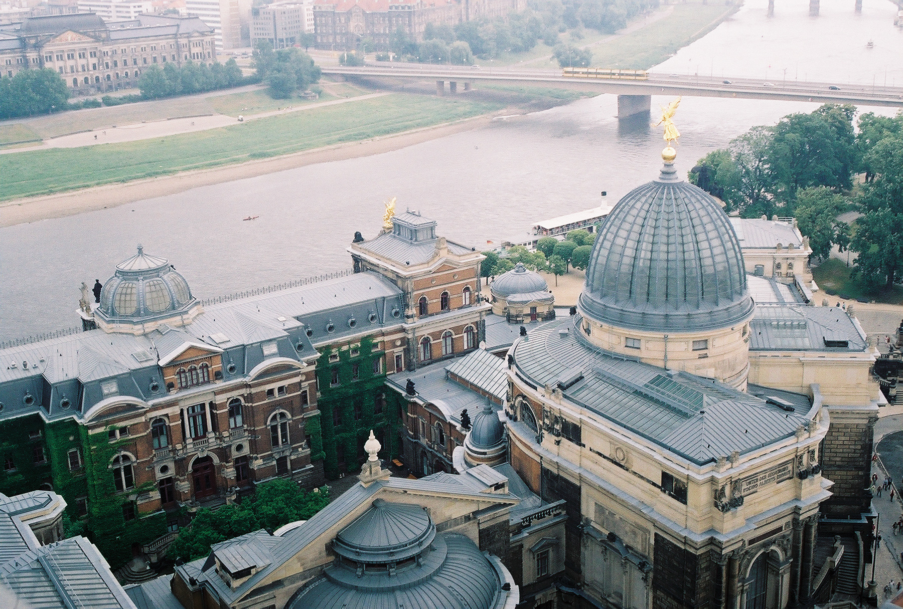 A view of the Elbe River with the glass dome of the Royal Academy of Arts building in the foreground - Dresden